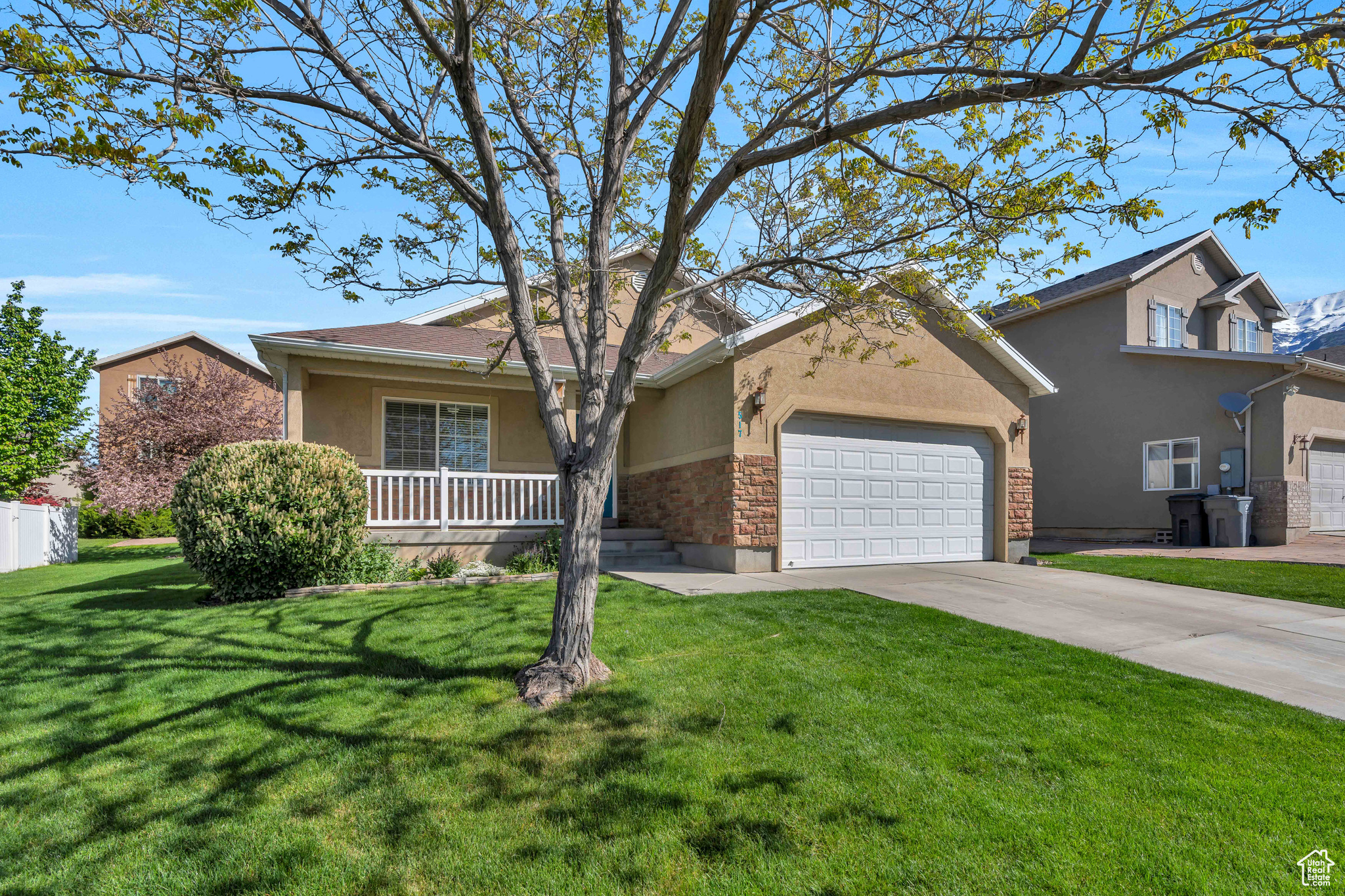 Ranch-style home with a garage and a front yard