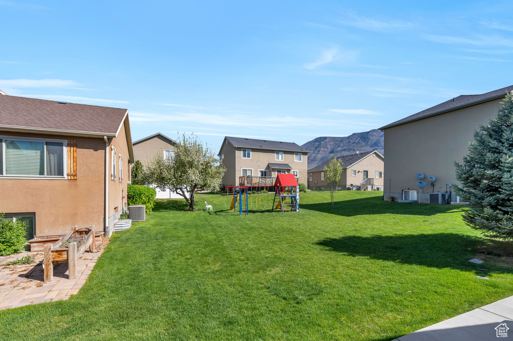 View of yard featuring a playground and central AC unit