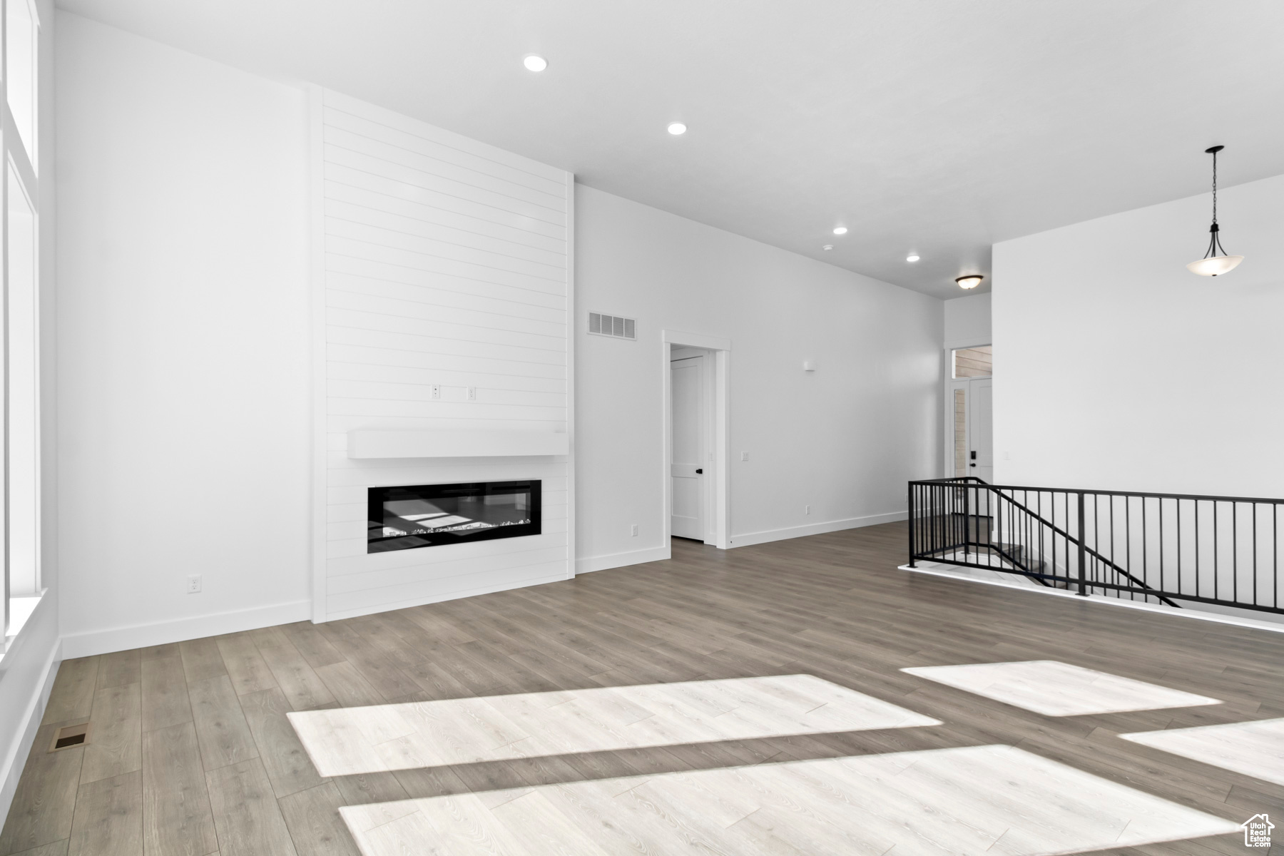Unfurnished living room featuring a fireplace and hardwood / wood-style flooring