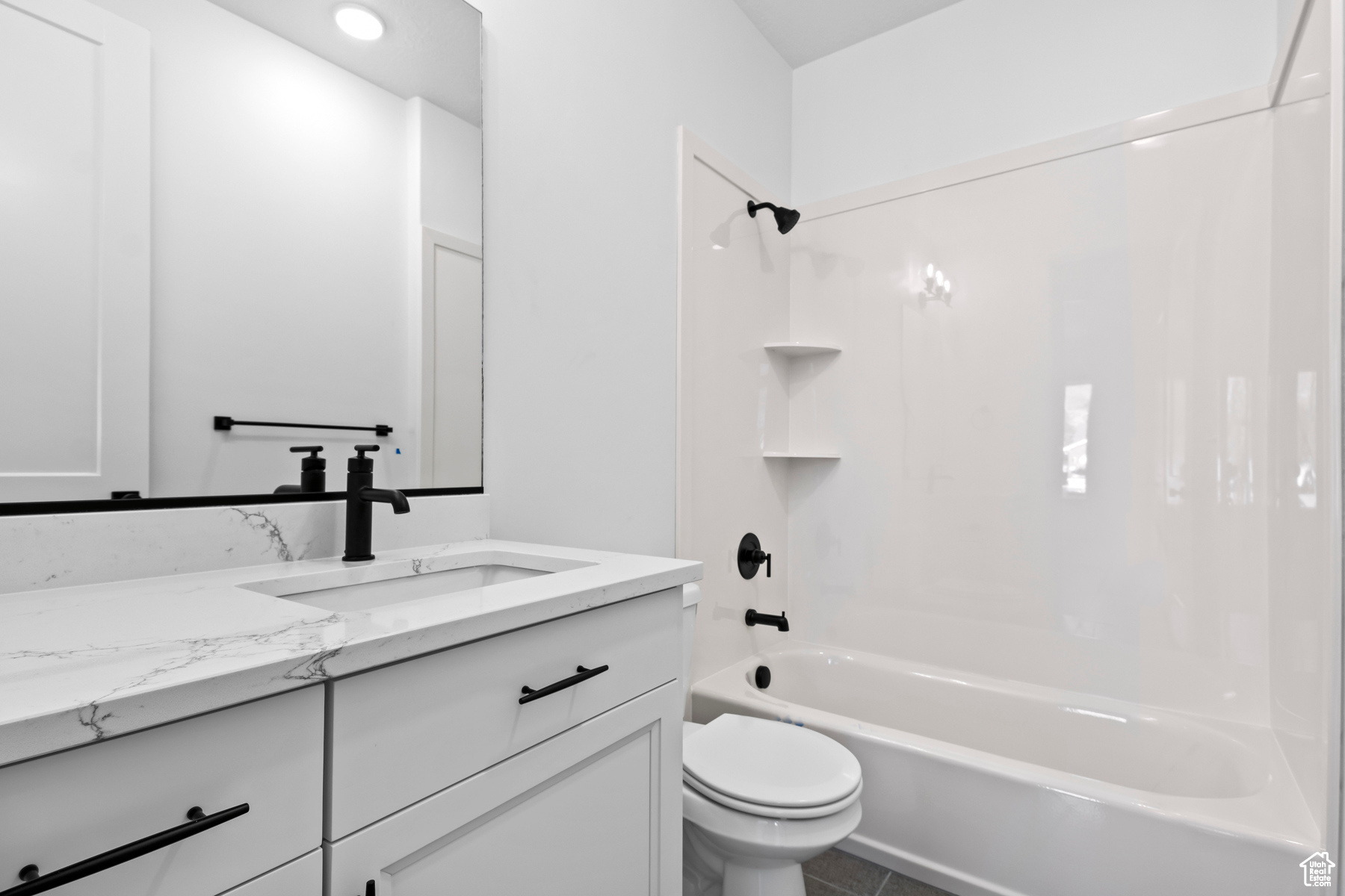 Full bathroom featuring shower / bath combination, toilet, tile floors, and vanity