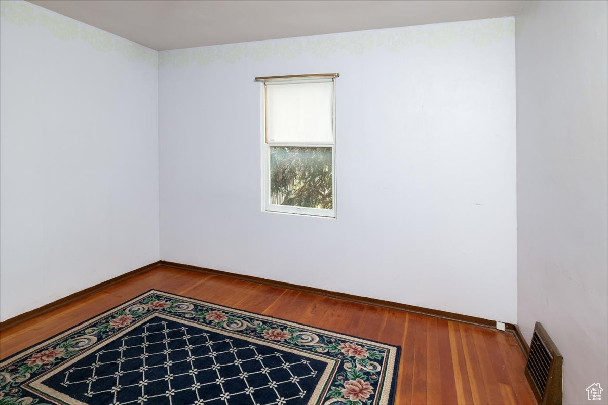 Bedroom 1 with hardwood / wood-style flooring