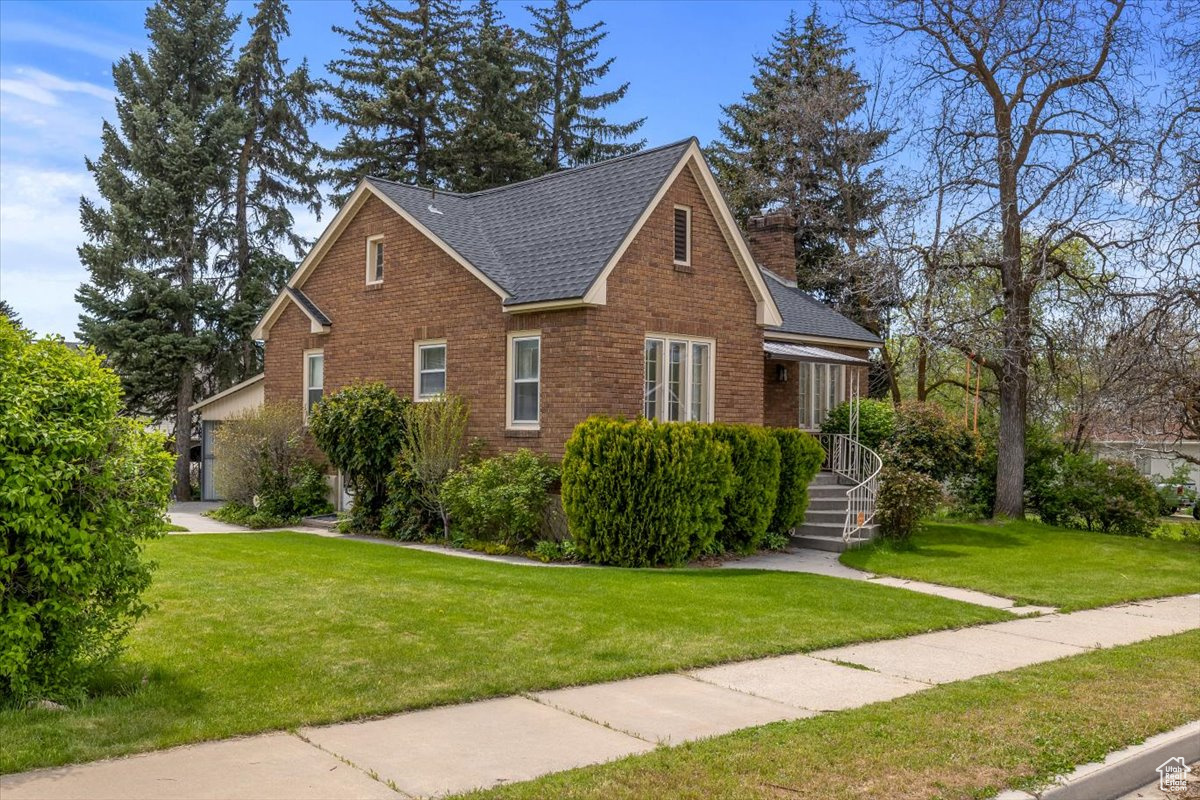 View of side of property featuring a yard