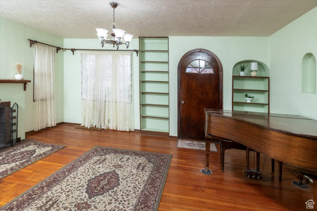 Living Room with arched door and built-in shelving