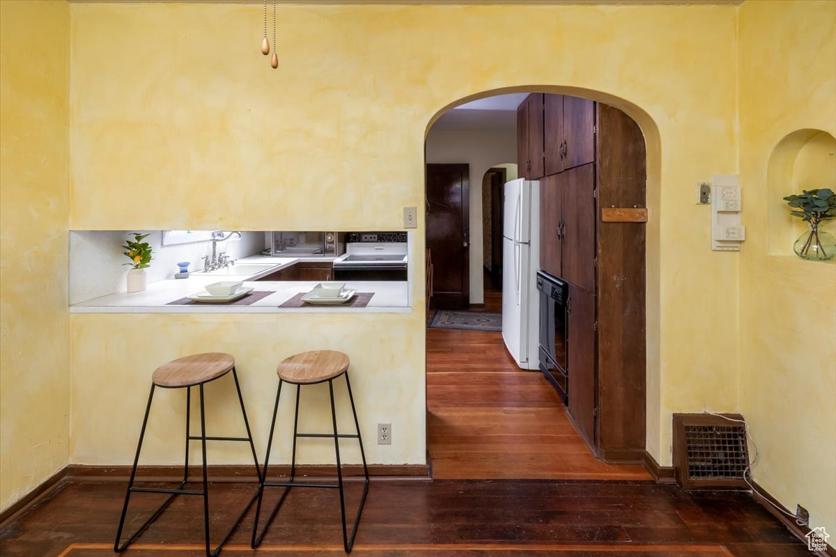 Kitchen featuring a peninsula and arched doorways and built-in's
