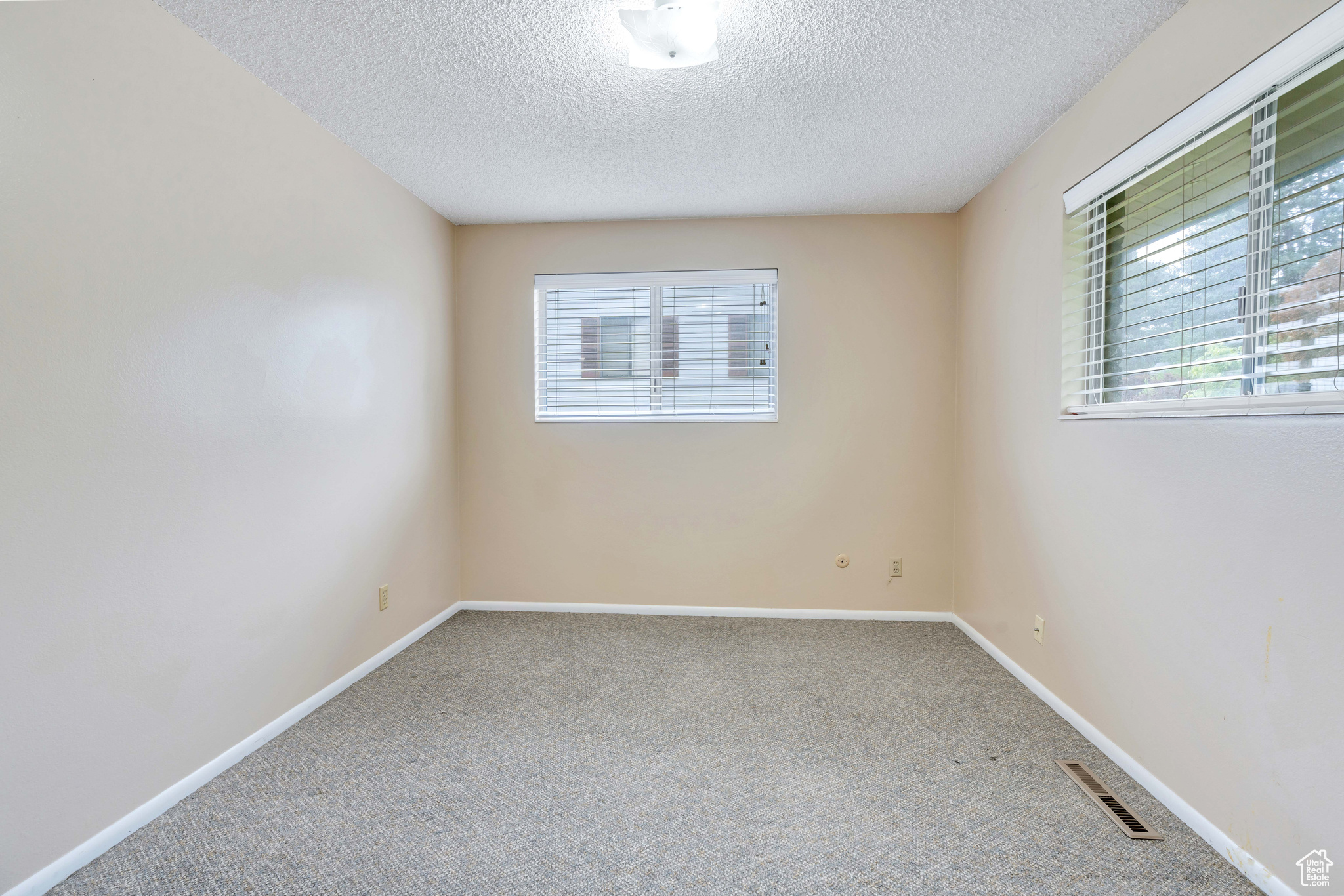 bedroom with a textured ceiling and carpet floors