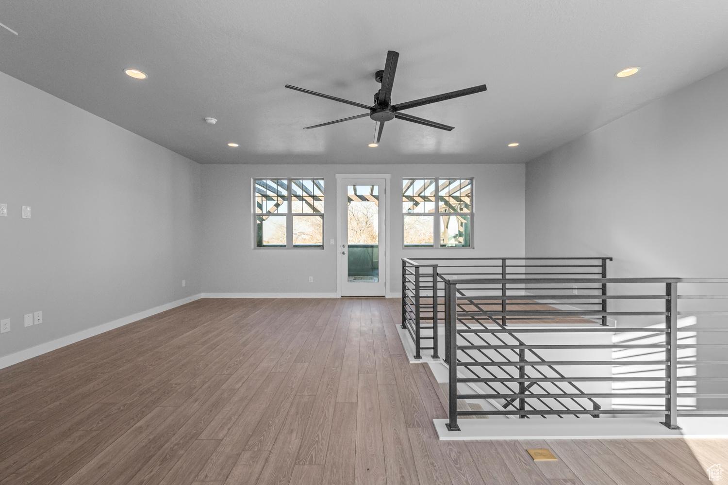 Empty room featuring hardwood / wood-style floors and ceiling fan