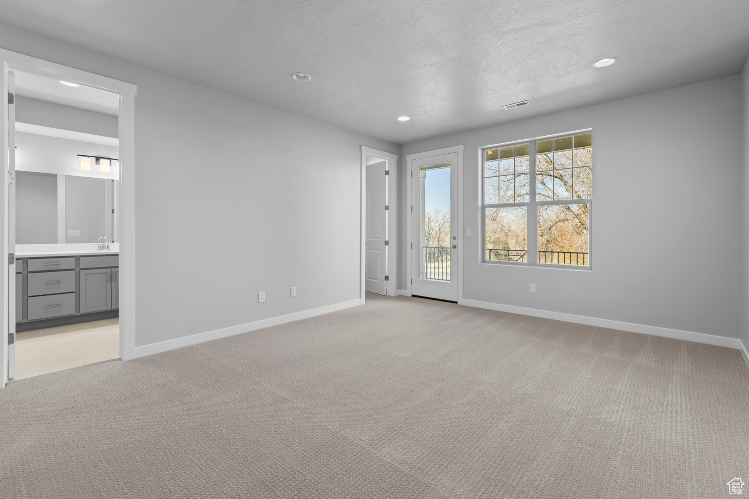 Spare room featuring light colored carpet