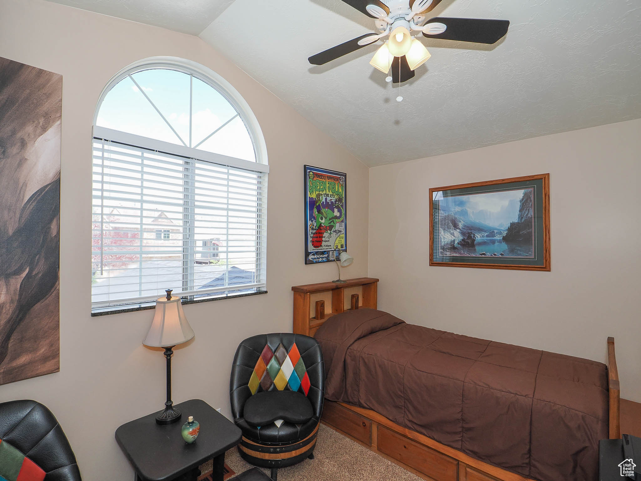 Bedroom with carpet flooring, ceiling fan, and lofted ceiling