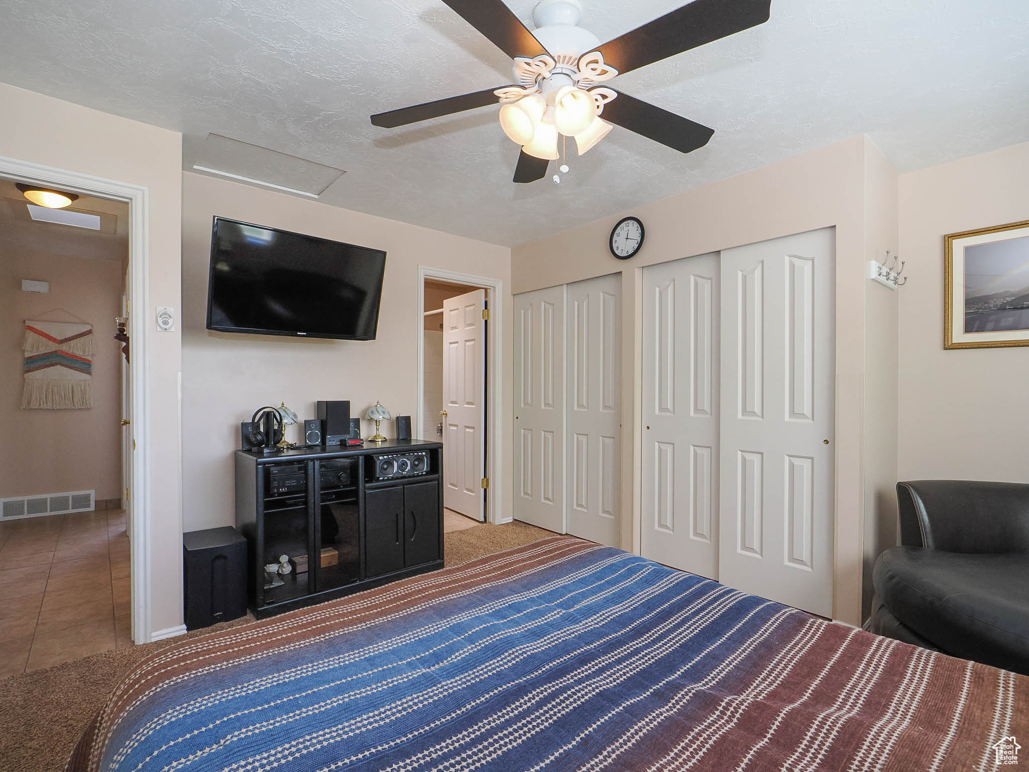 Tiled bedroom with ceiling fan