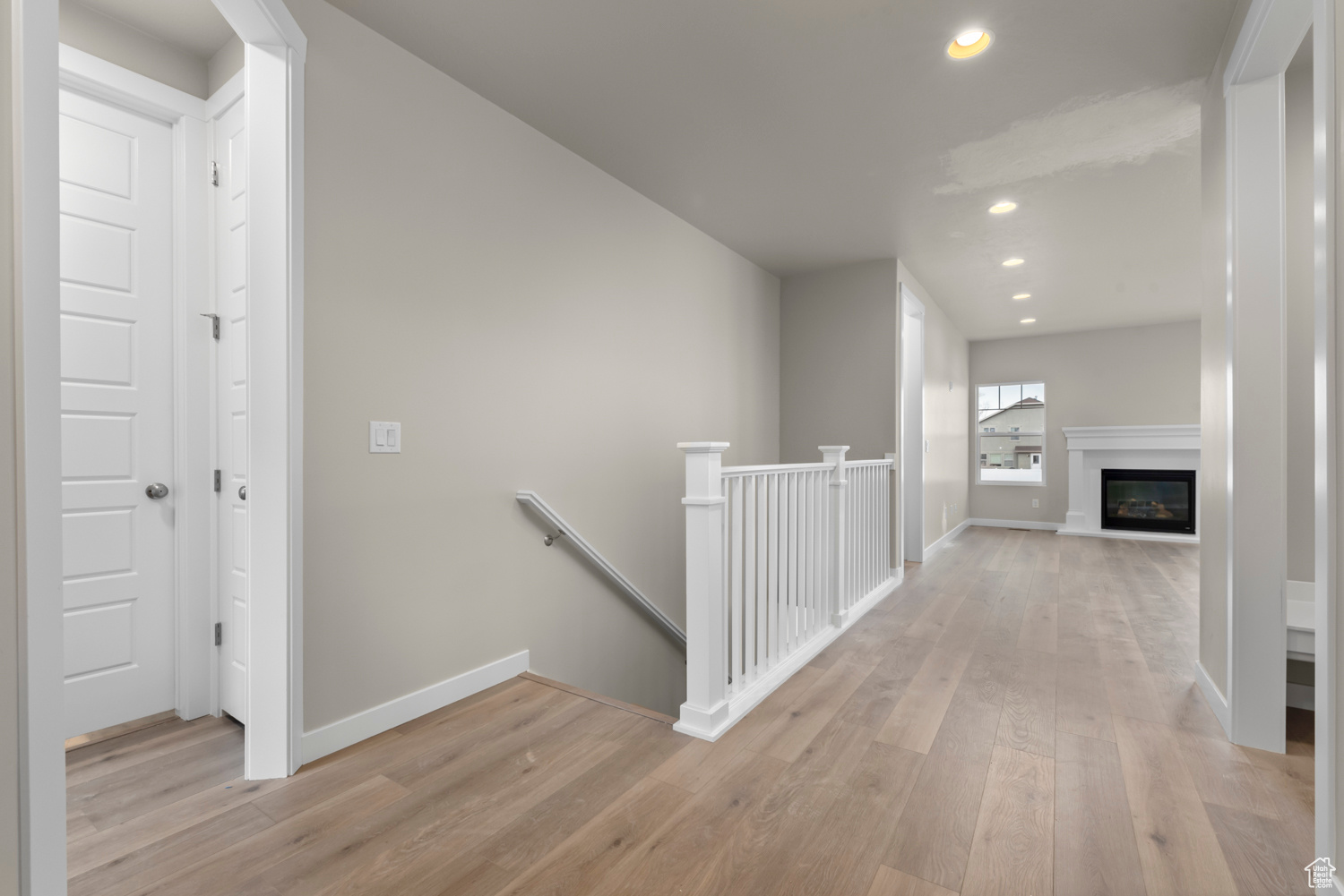 Hallway with light hardwood / wood-style floors