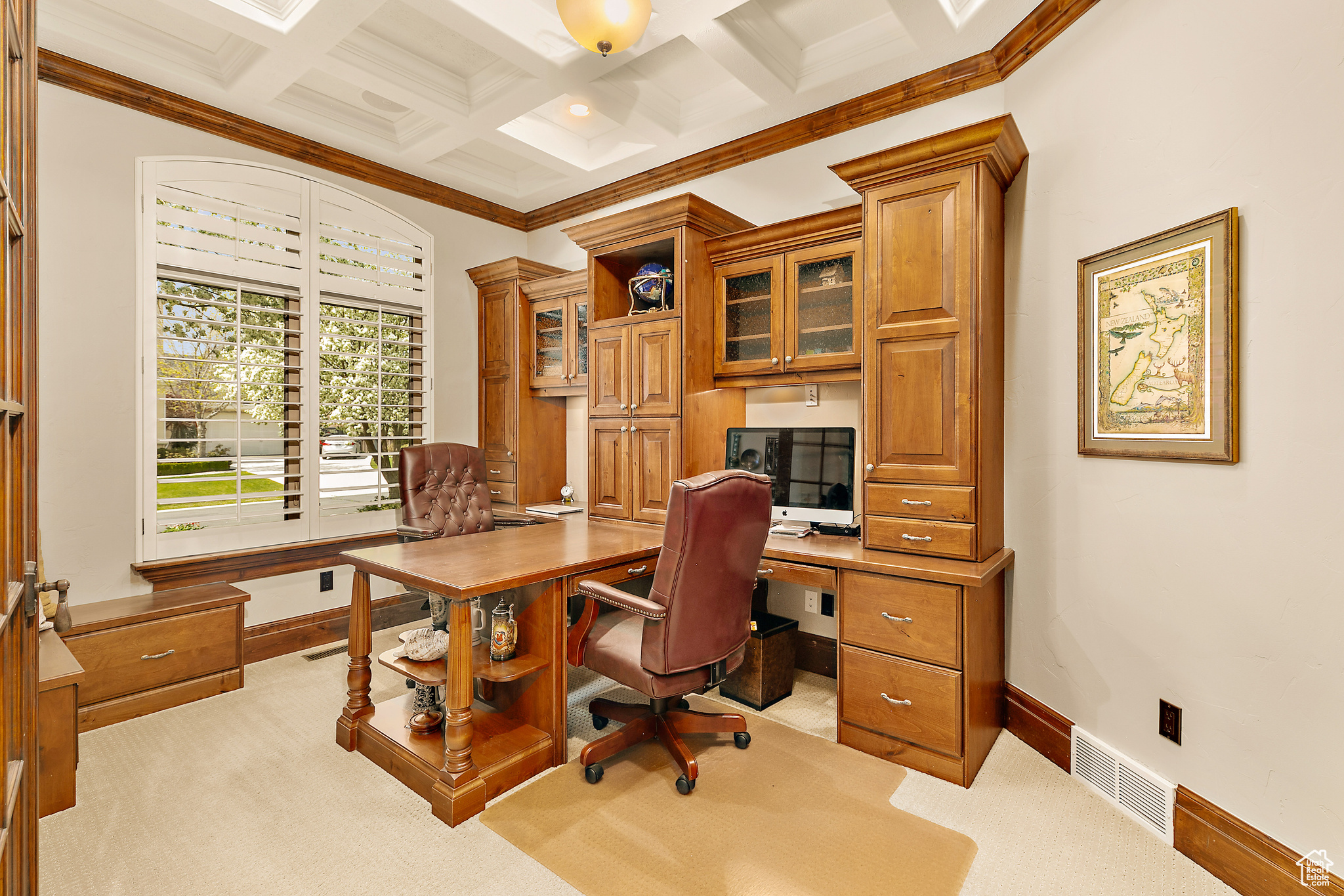 Office area featuring coffered ceiling, light colored carpet, beam ceiling, and crown molding