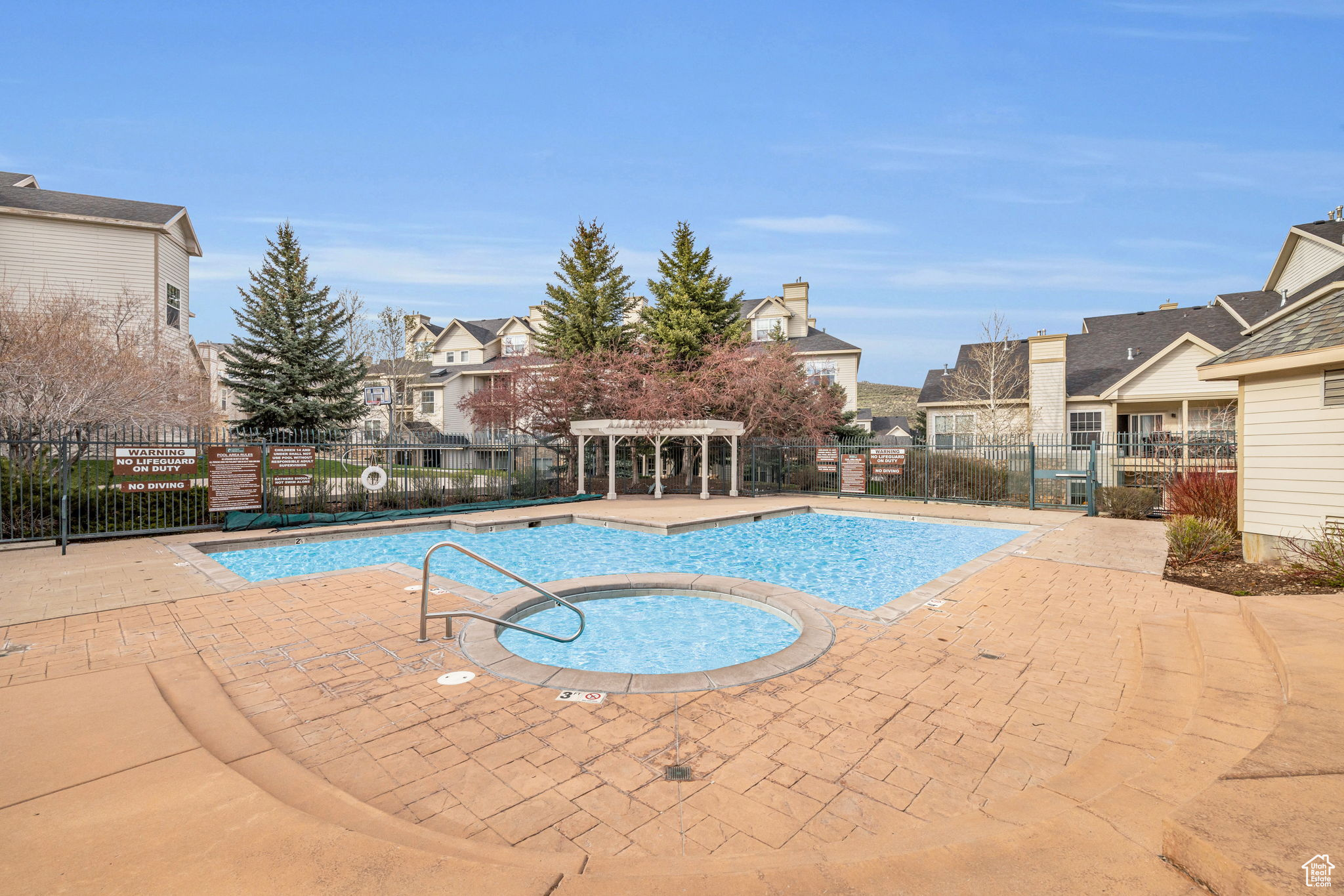 View of pool featuring a patio and a community hot tub