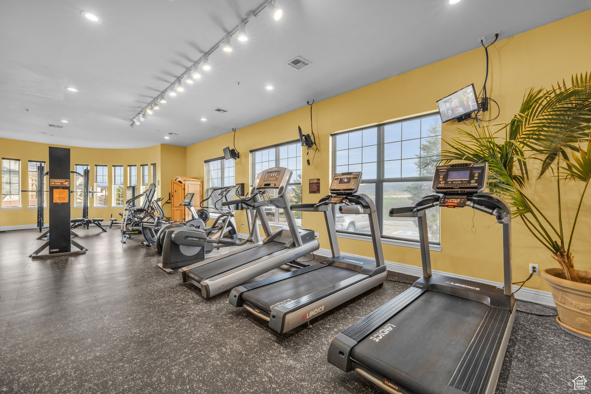 Exercise room featuring track lighting