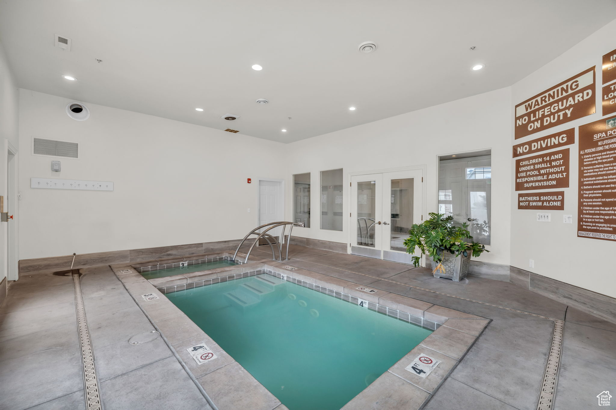 View of pool with french doors