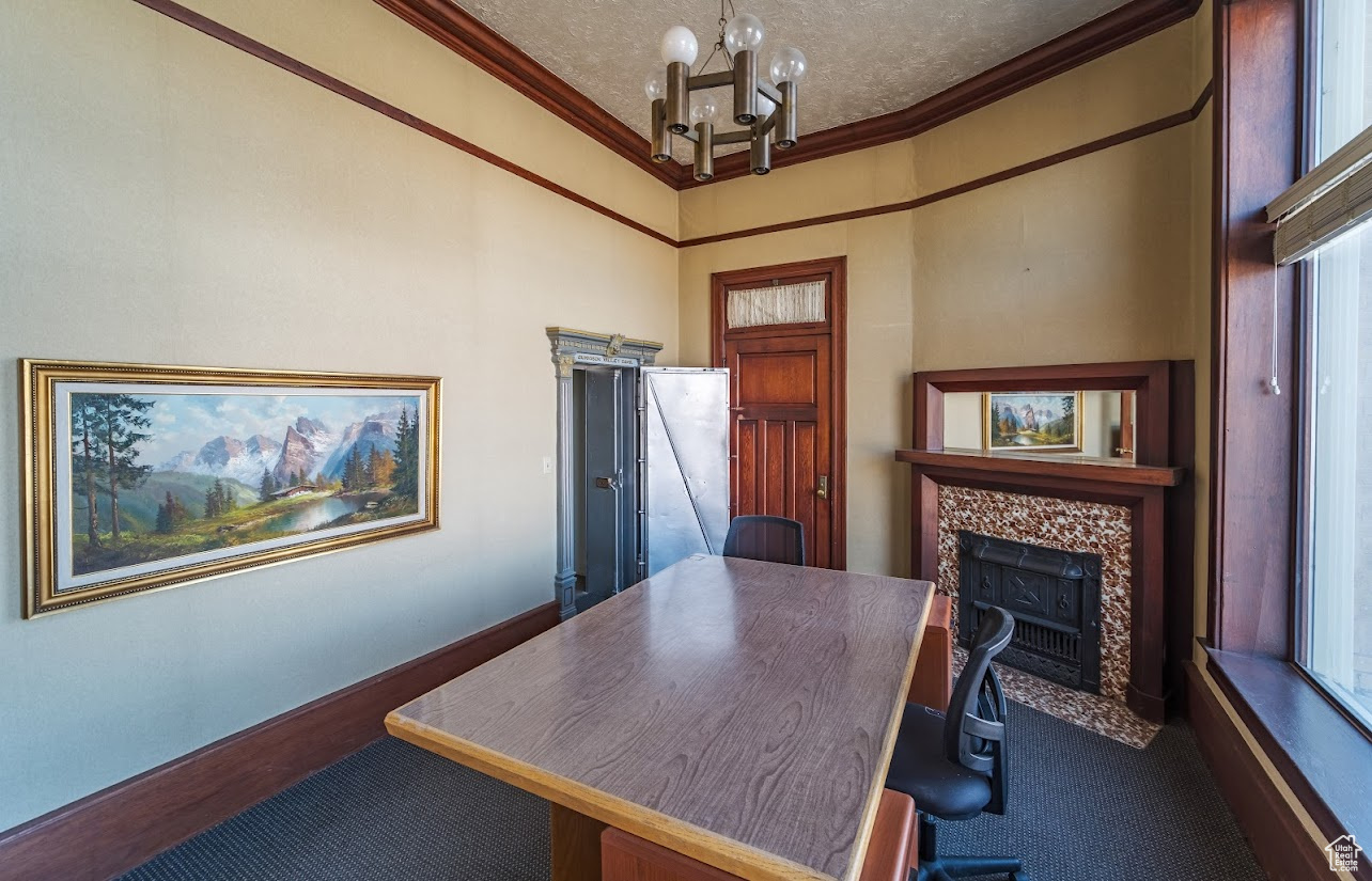 This classic Private office features a original tile fireplace, notable chandelier, crown molding, its own private safe, and large picture windows with its own entrance.