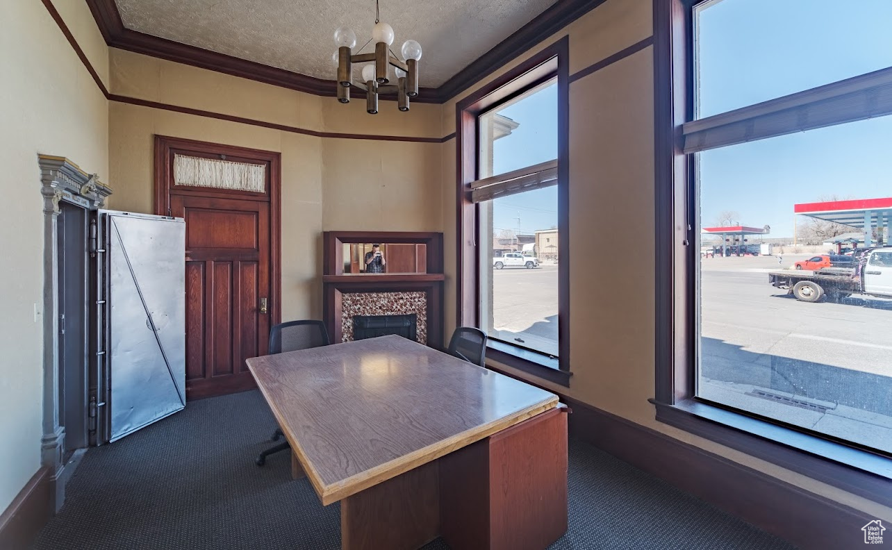 Another view of this handsome private 5th office complete with stunning fireplace,  ornamental molding, an inviting chandelier, lovely picture windows, and private Safe.