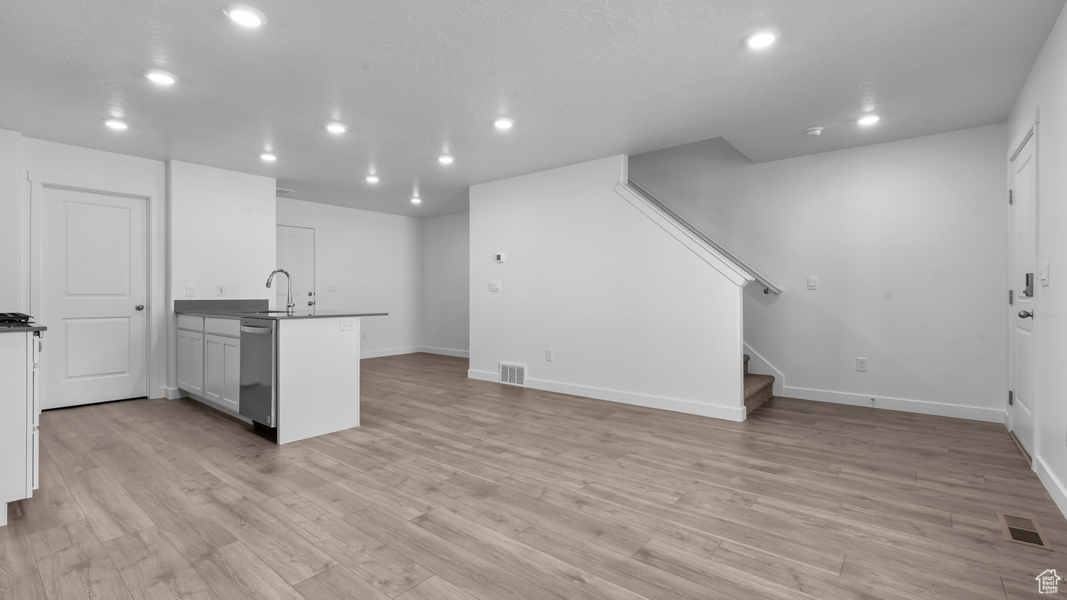 Interior space with light hardwood / wood-style flooring and sink