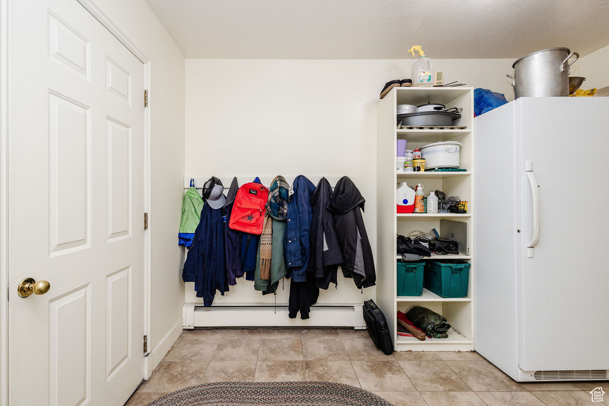 Mudroom with baseboard heating and light tile floors