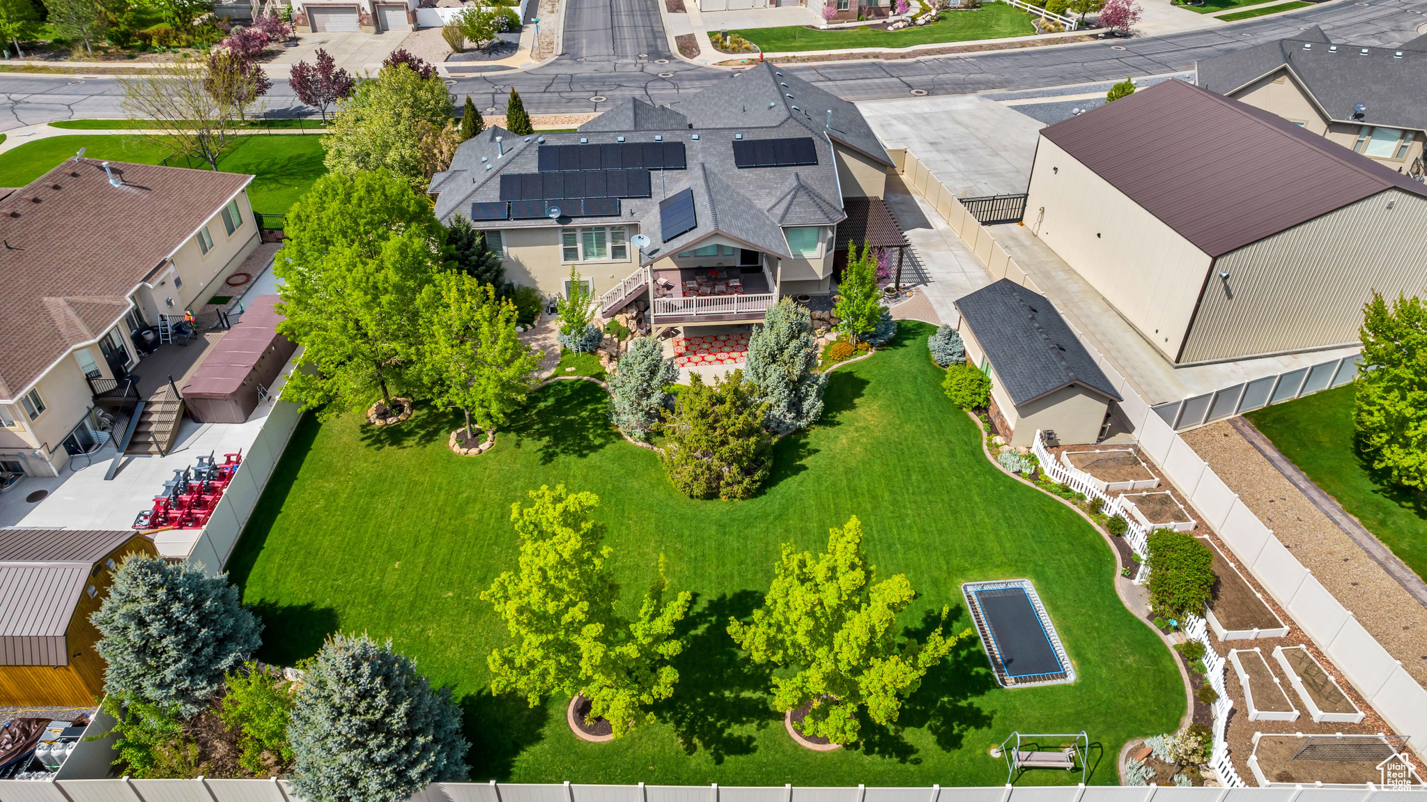 Bird's eye view of the yard, in-ground trampoline, garden, and mature trees