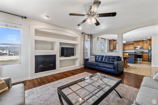 Family room with built in features and ceiling fan
