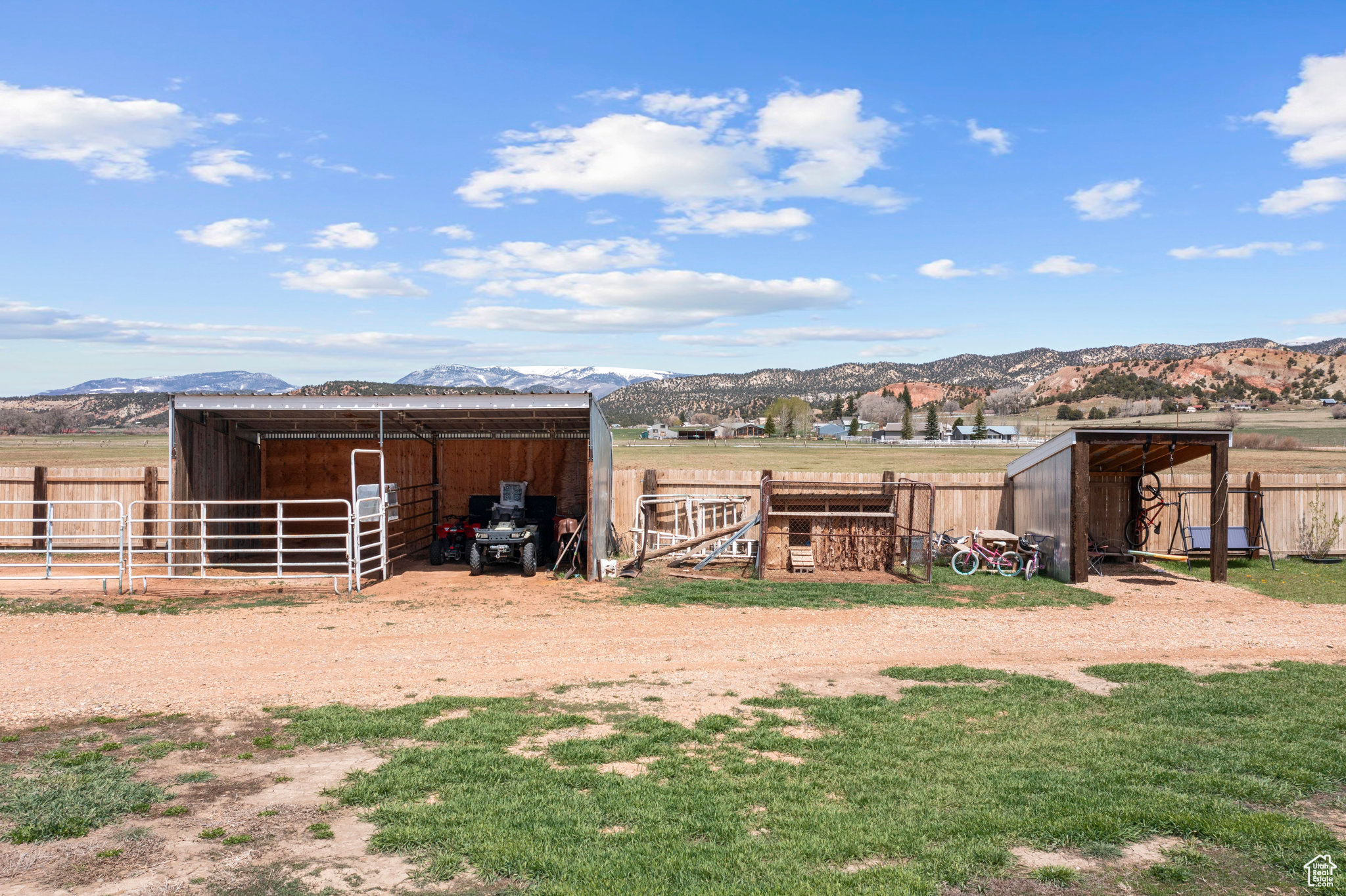 View of horse barn featuring a mountain view and an outdoor structure and chicken coop