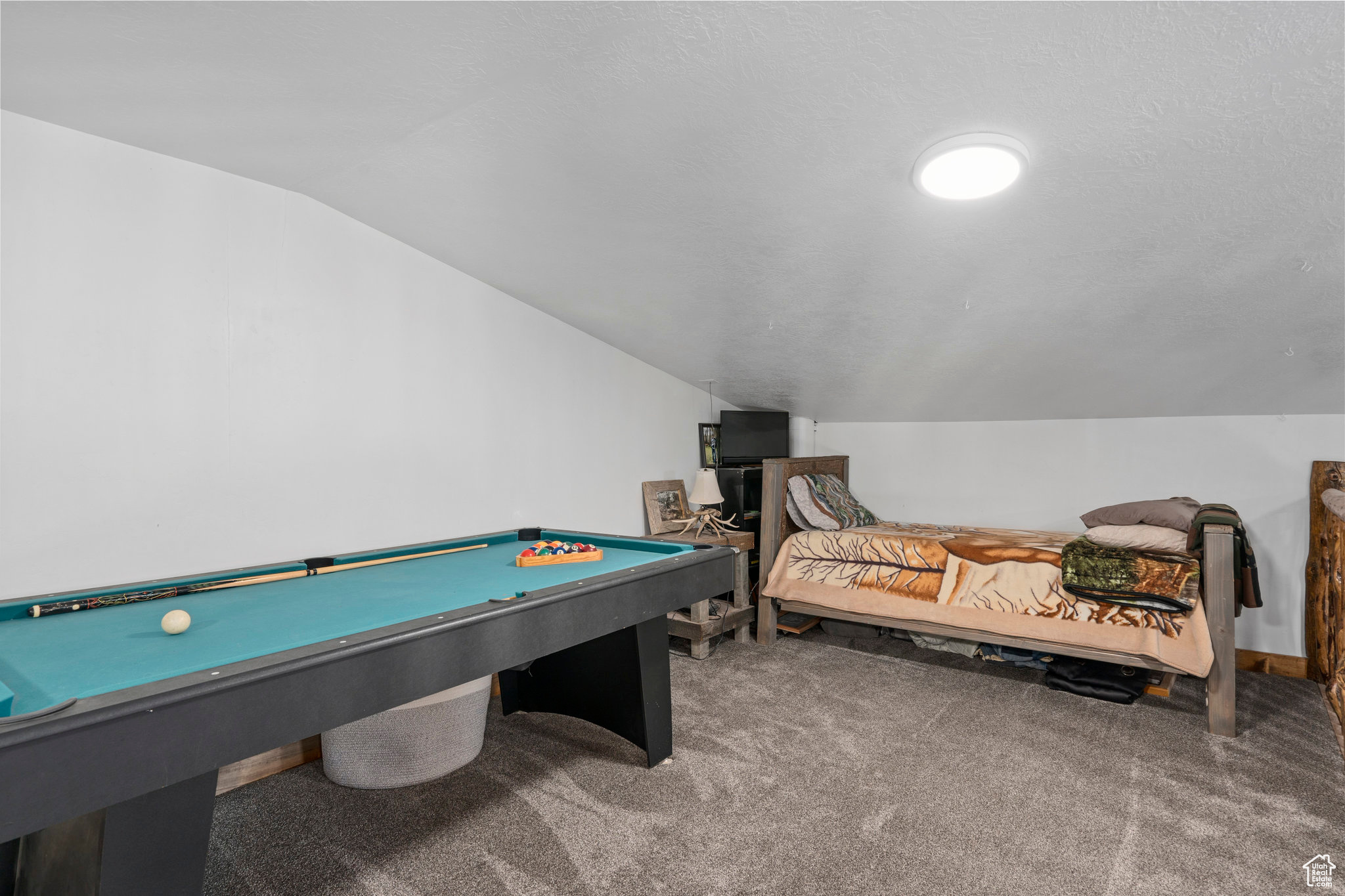 Game room with lofted ceiling, carpet, and pool table