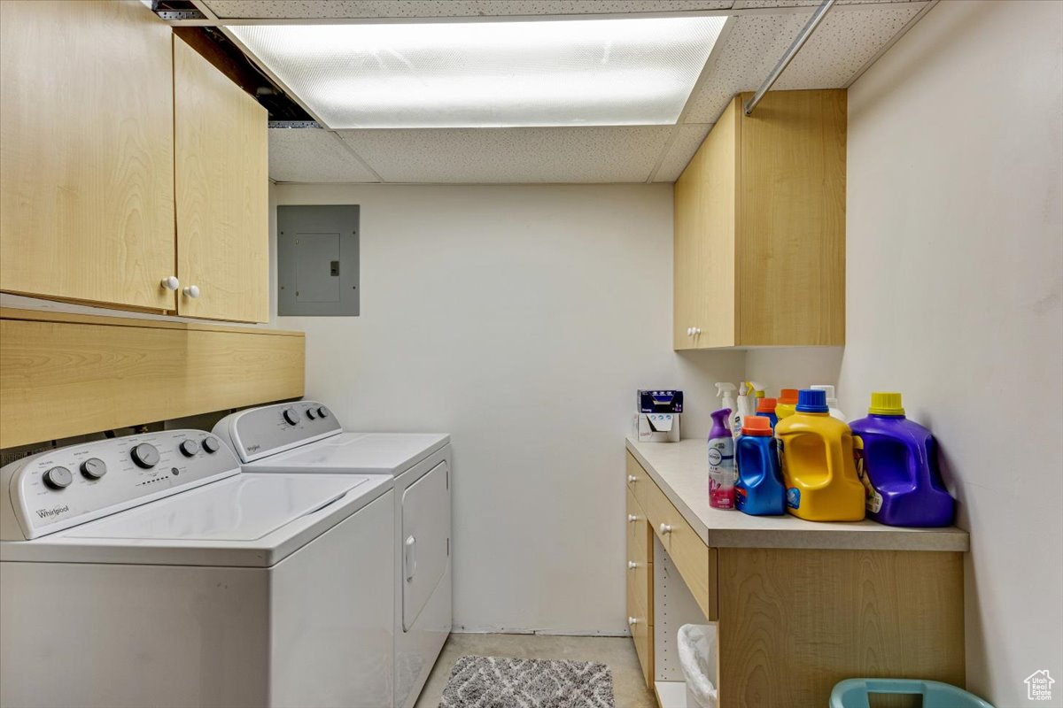 Laundry room with independent washer and dryer and cabinets