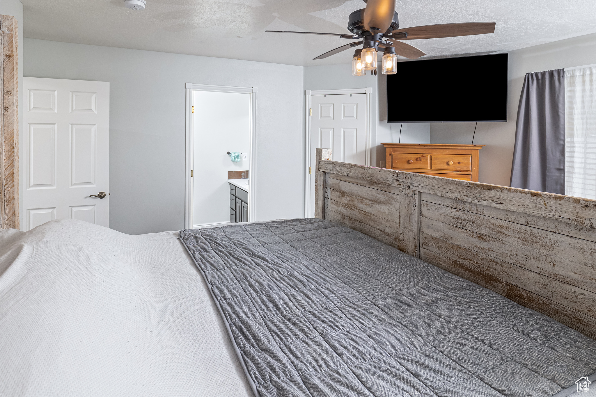 Primary bedroom featuring a closet, ceiling fan, and ensuite bath