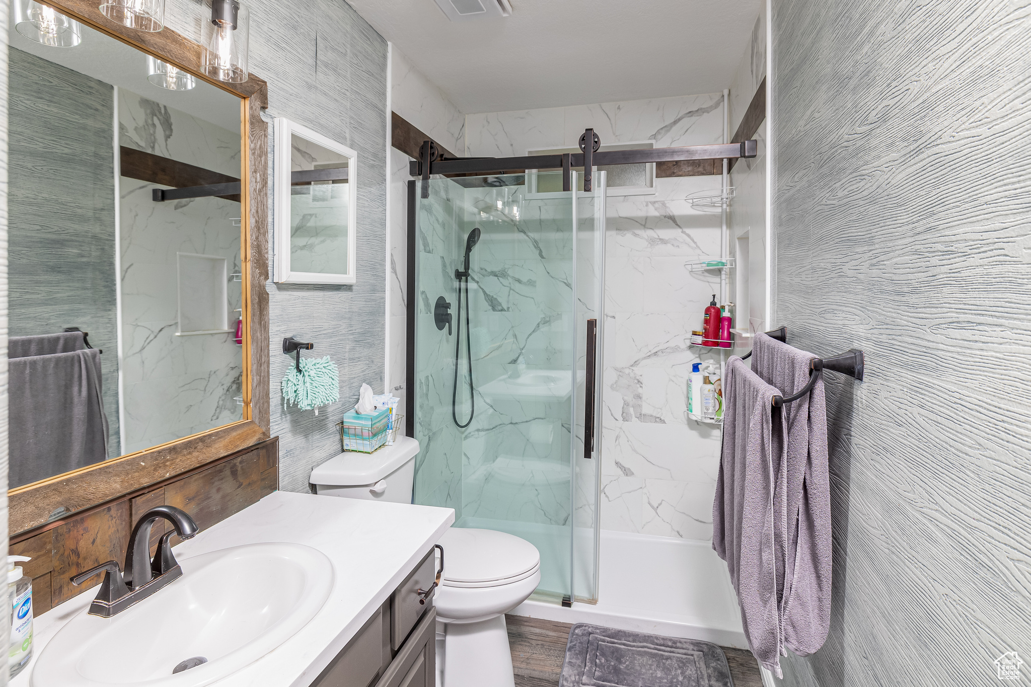 Bathroom with wood-type flooring, oversized vanity, and toilet