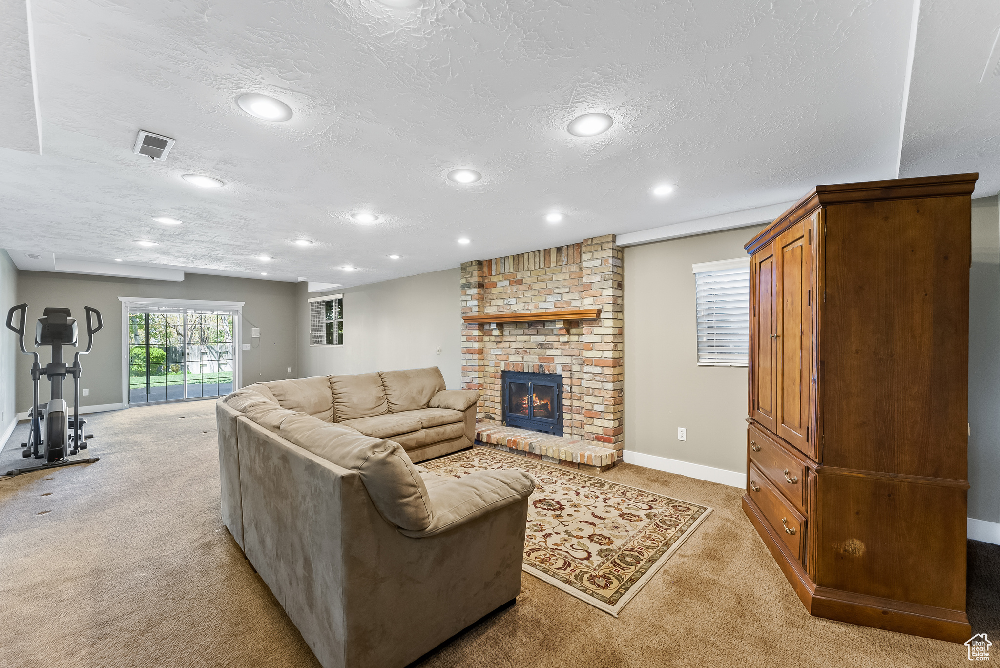 Lower level large family room with inviting fireplace and walkout to backyard