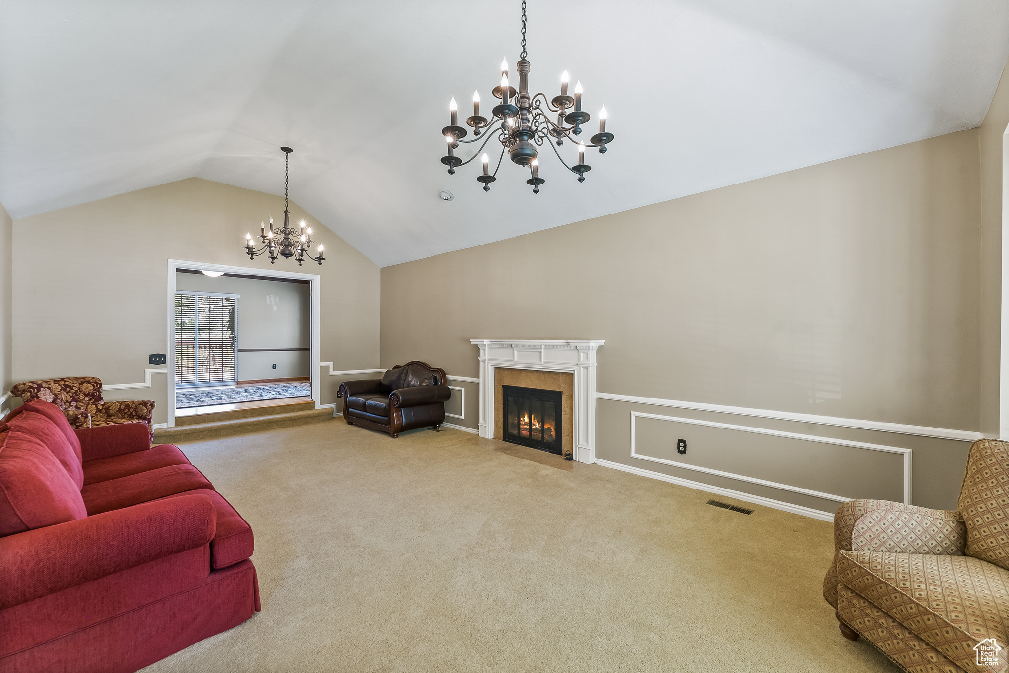 Formal living room with vaulted ceilings and fireplace