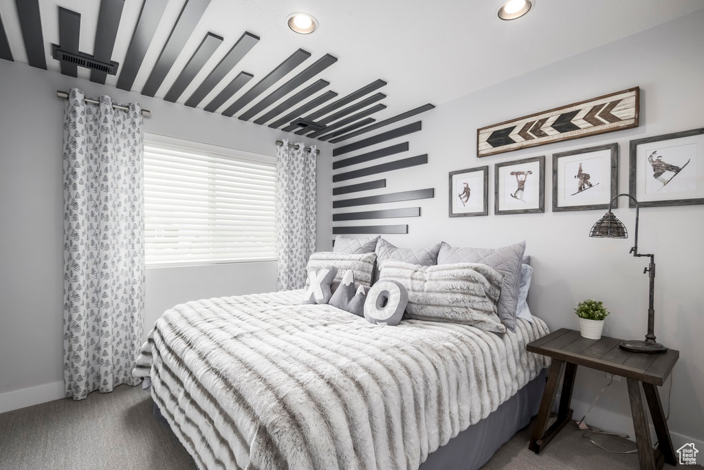 Bedroom featuring carpet floors and custom wall design