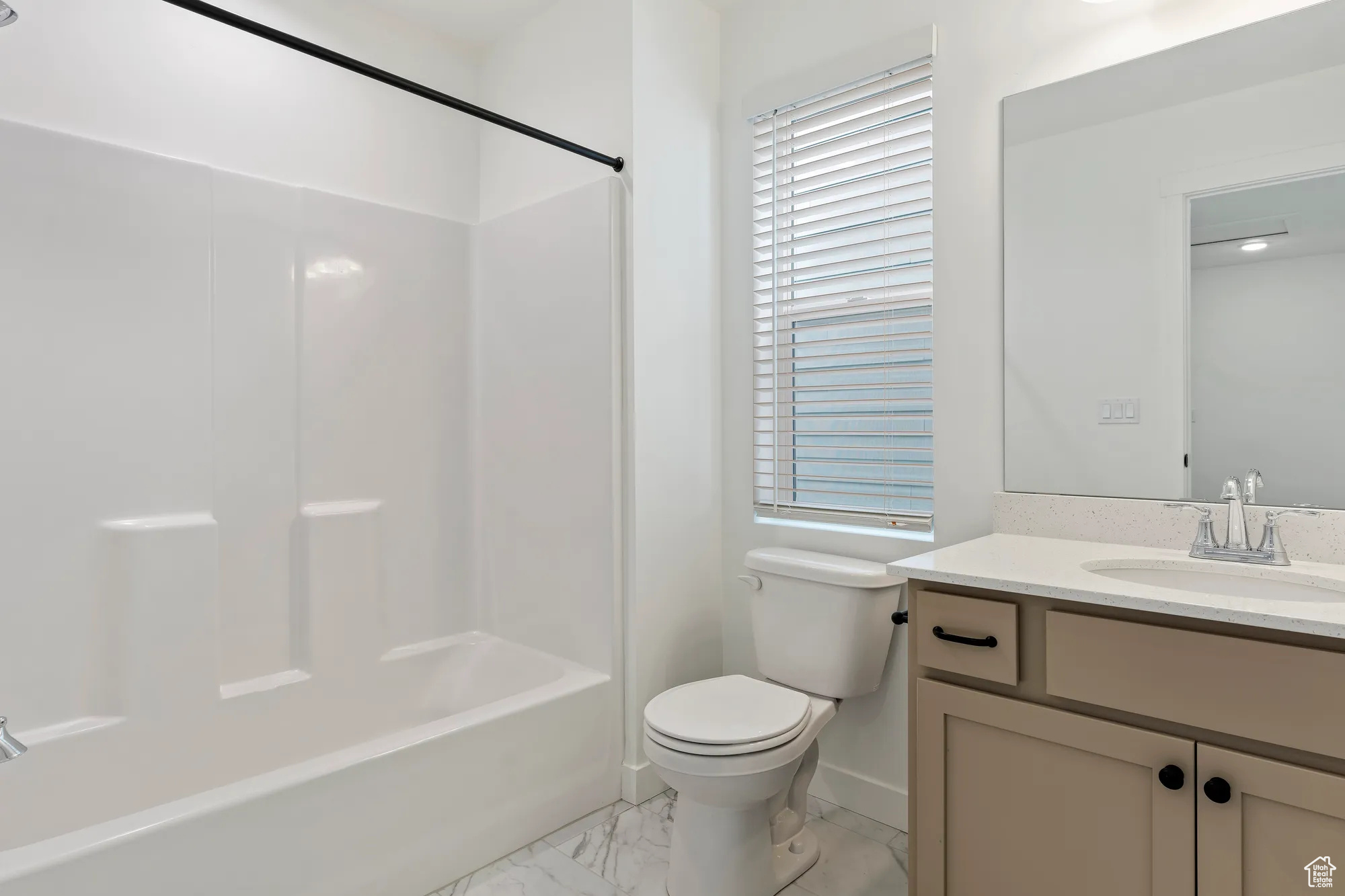 Full bathroom with shower / bathing tub combination, vanity, toilet, and tile flooring