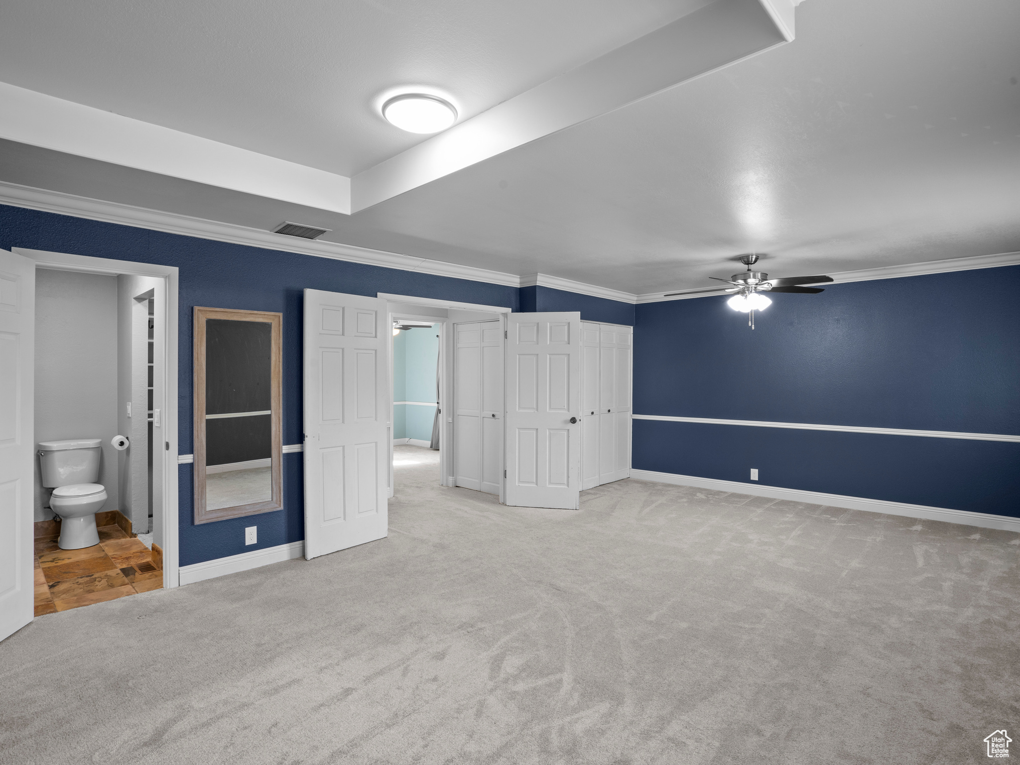 Interior space featuring ceiling fan and crown molding