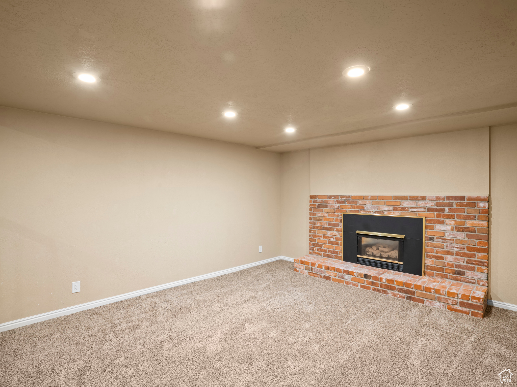 Unfurnished living room with a fireplace and carpet floors