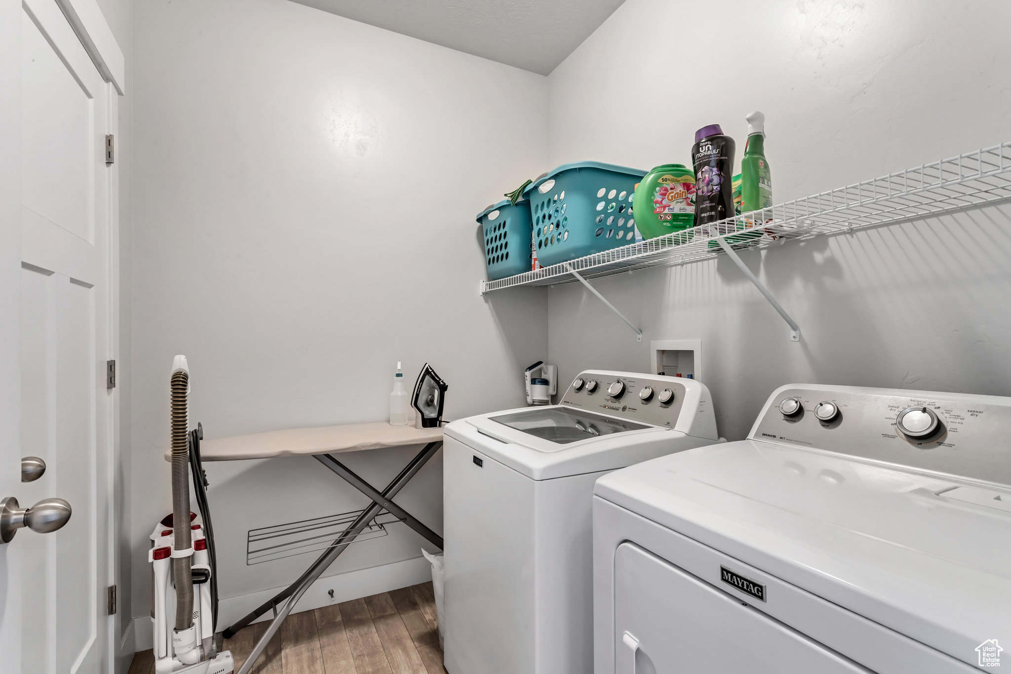 Clothes washing area with independent washer and dryer, hookup for a washing machine, and hardwood / wood-style flooring