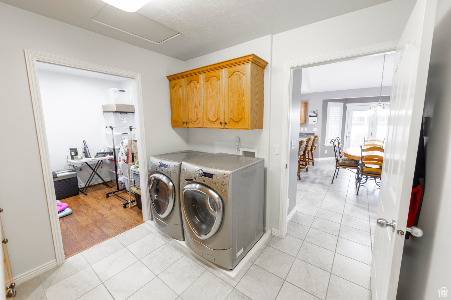 Laundry area with cabinets, hookup for a washing machine, light tile flooring, and washer and clothes dryer (included).  Bonus Room can be an office or an extra Pantry