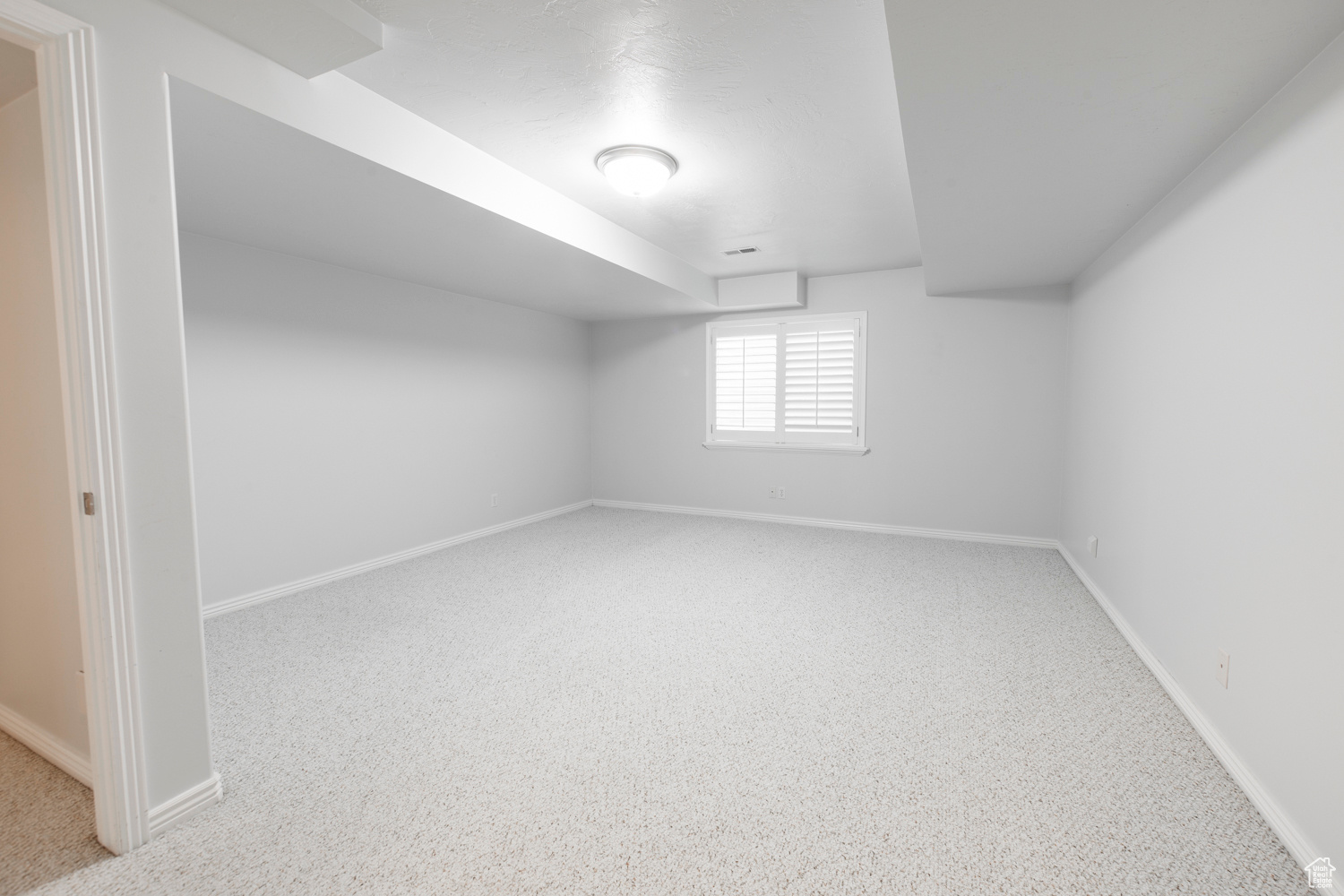 2nd downstairs bedroom with carpet flooring