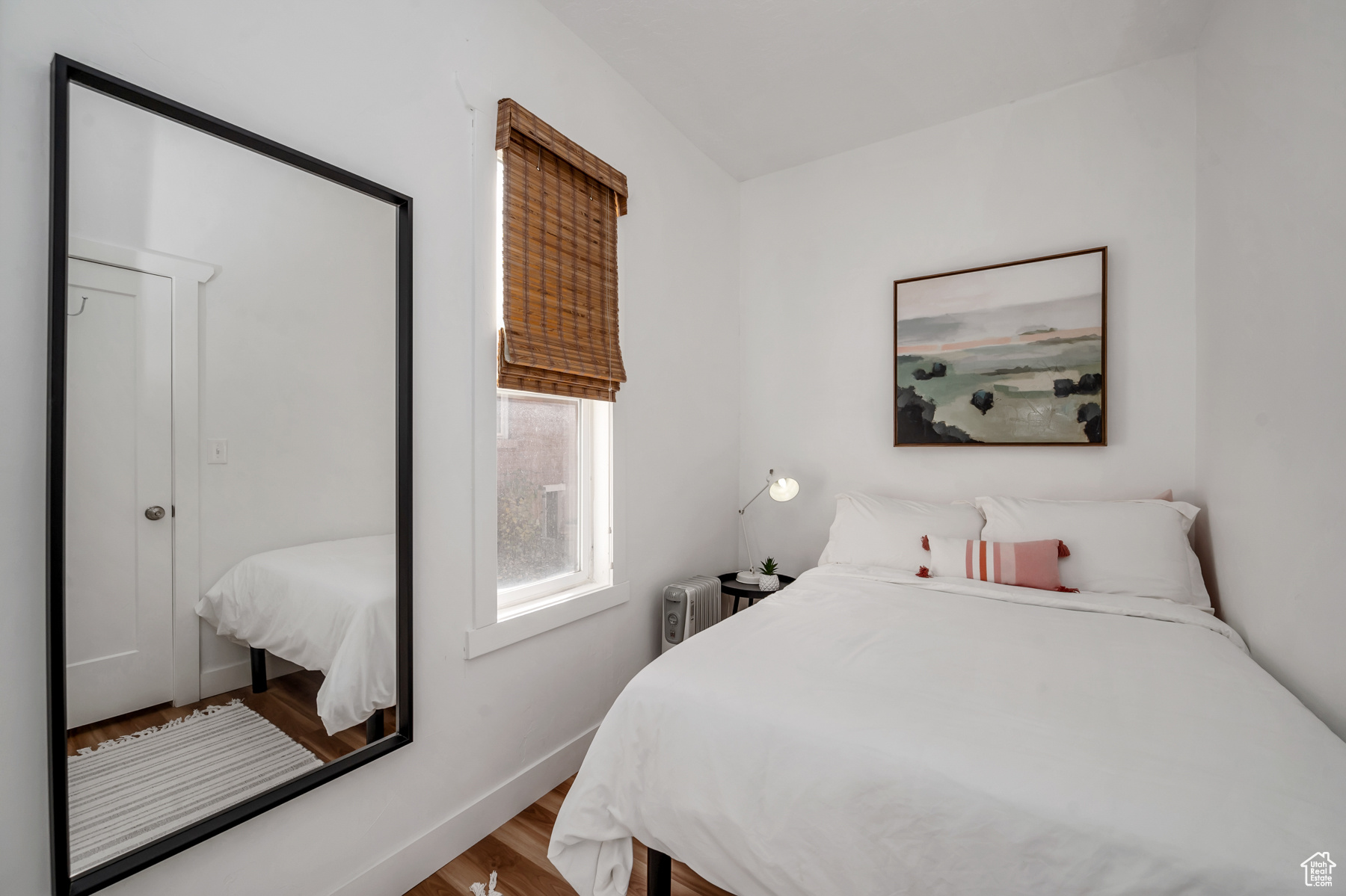 Bedroom with radiator heating unit and hardwood / wood-style floors