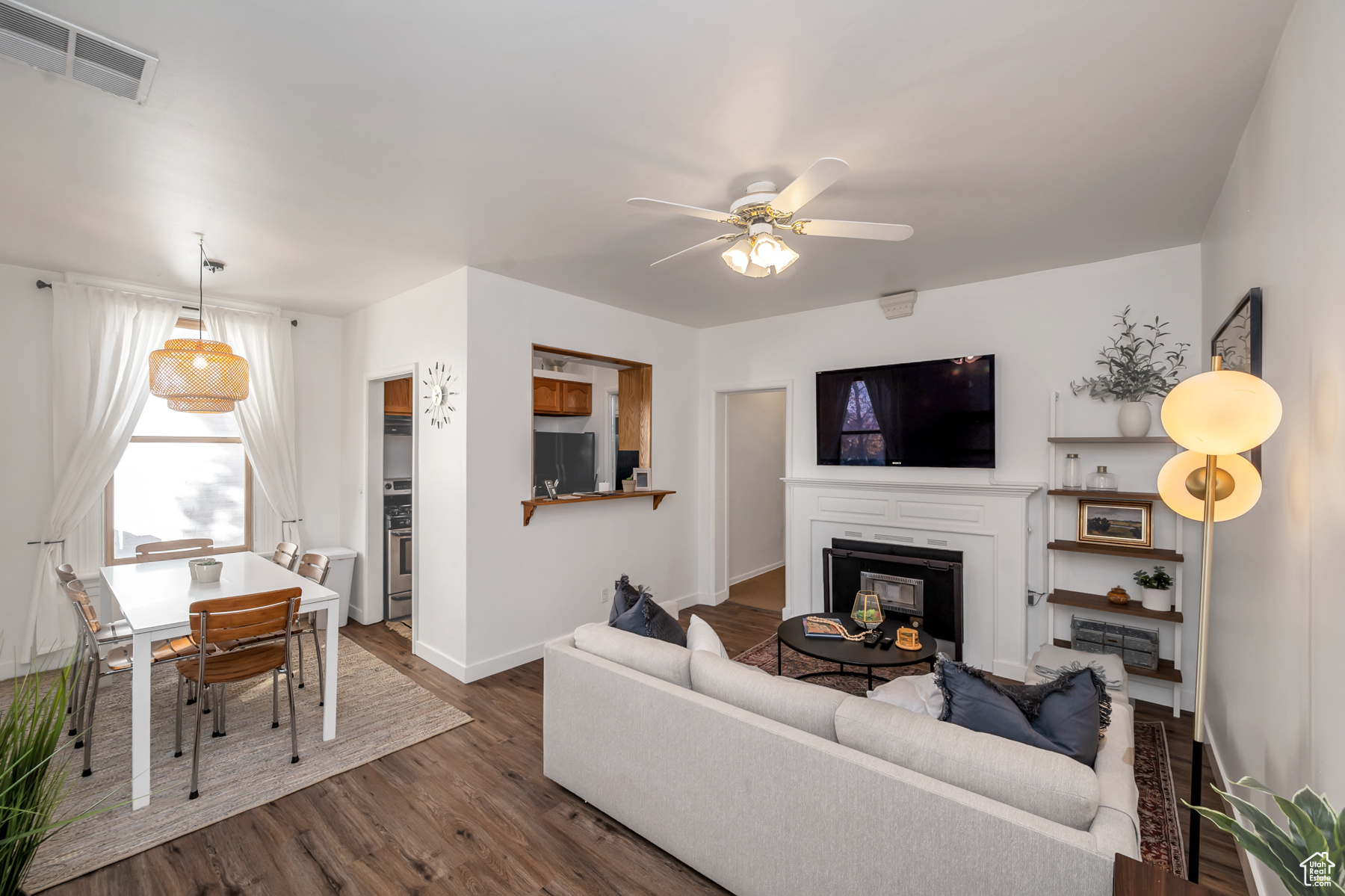 Living room featuring wood-type flooring and ceiling fan