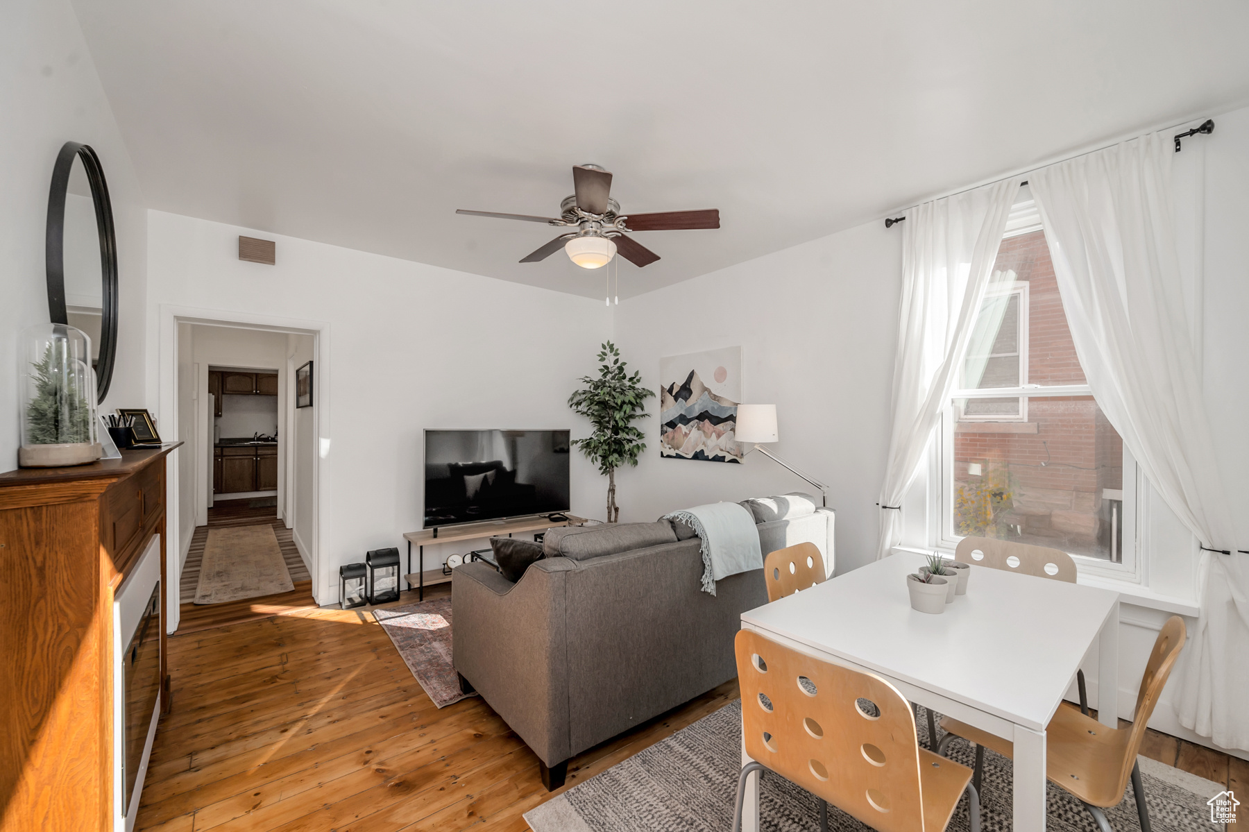 Living room featuring ceiling fan and light wood-type flooring