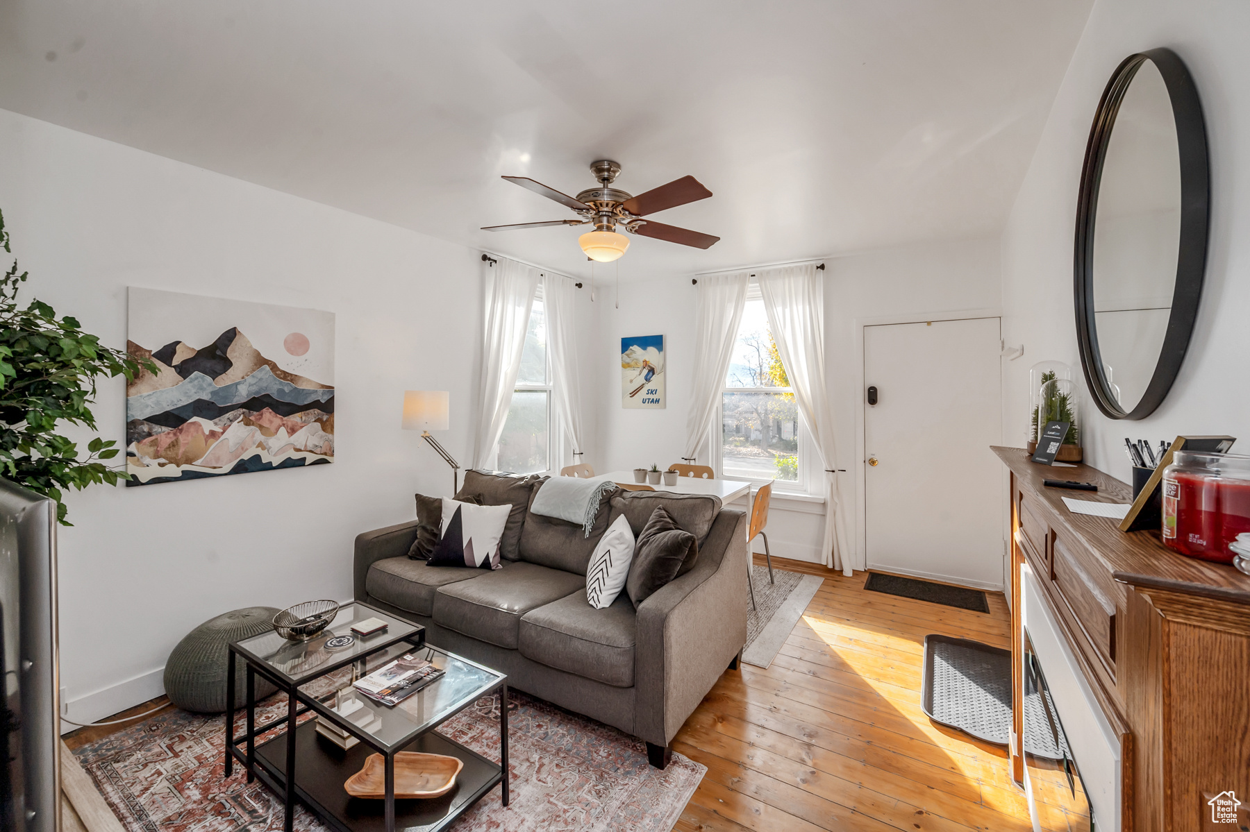 Living room featuring ceiling fan and light wood-type flooring