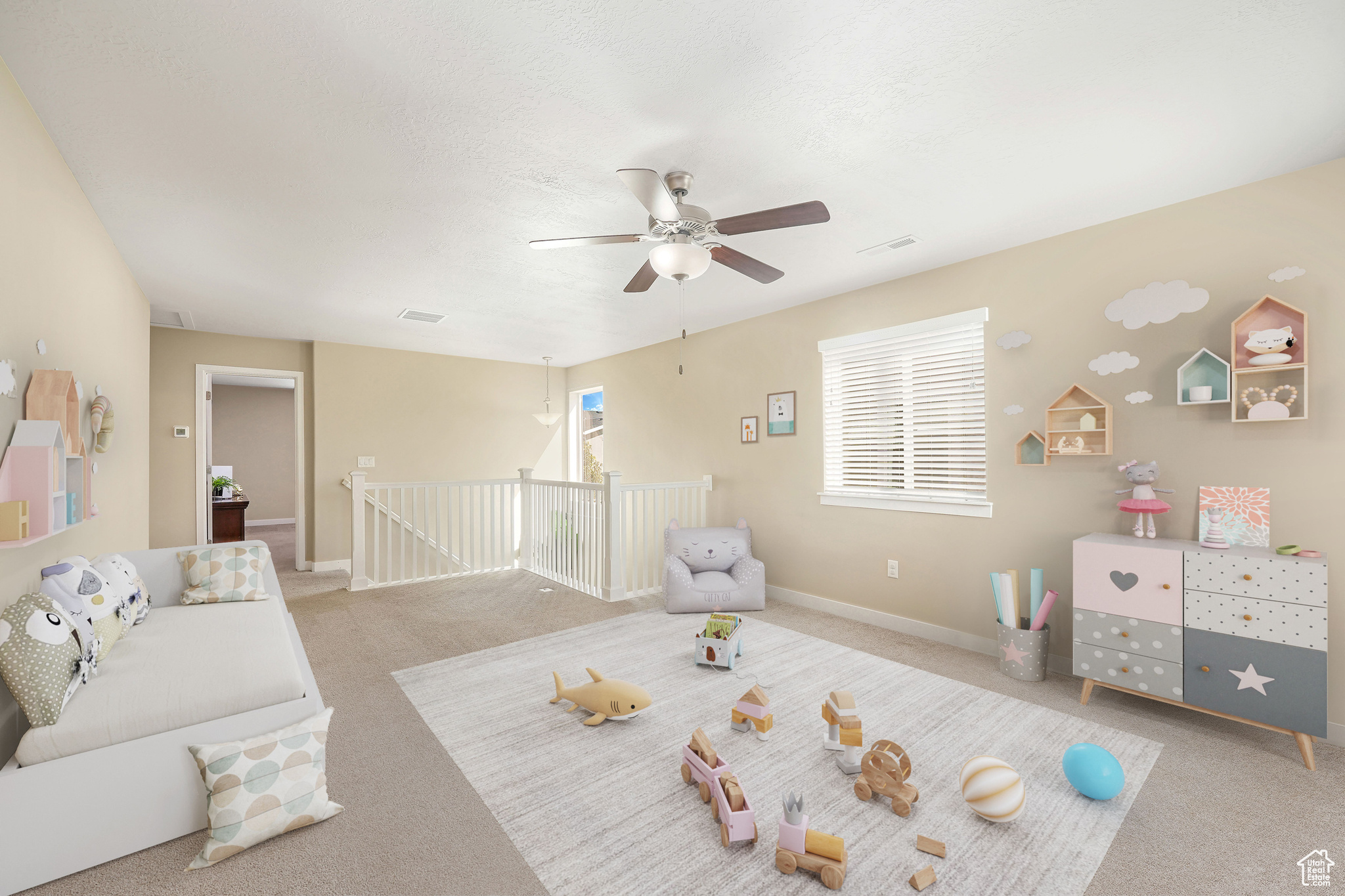 Playroom featuring light carpet and ceiling fan