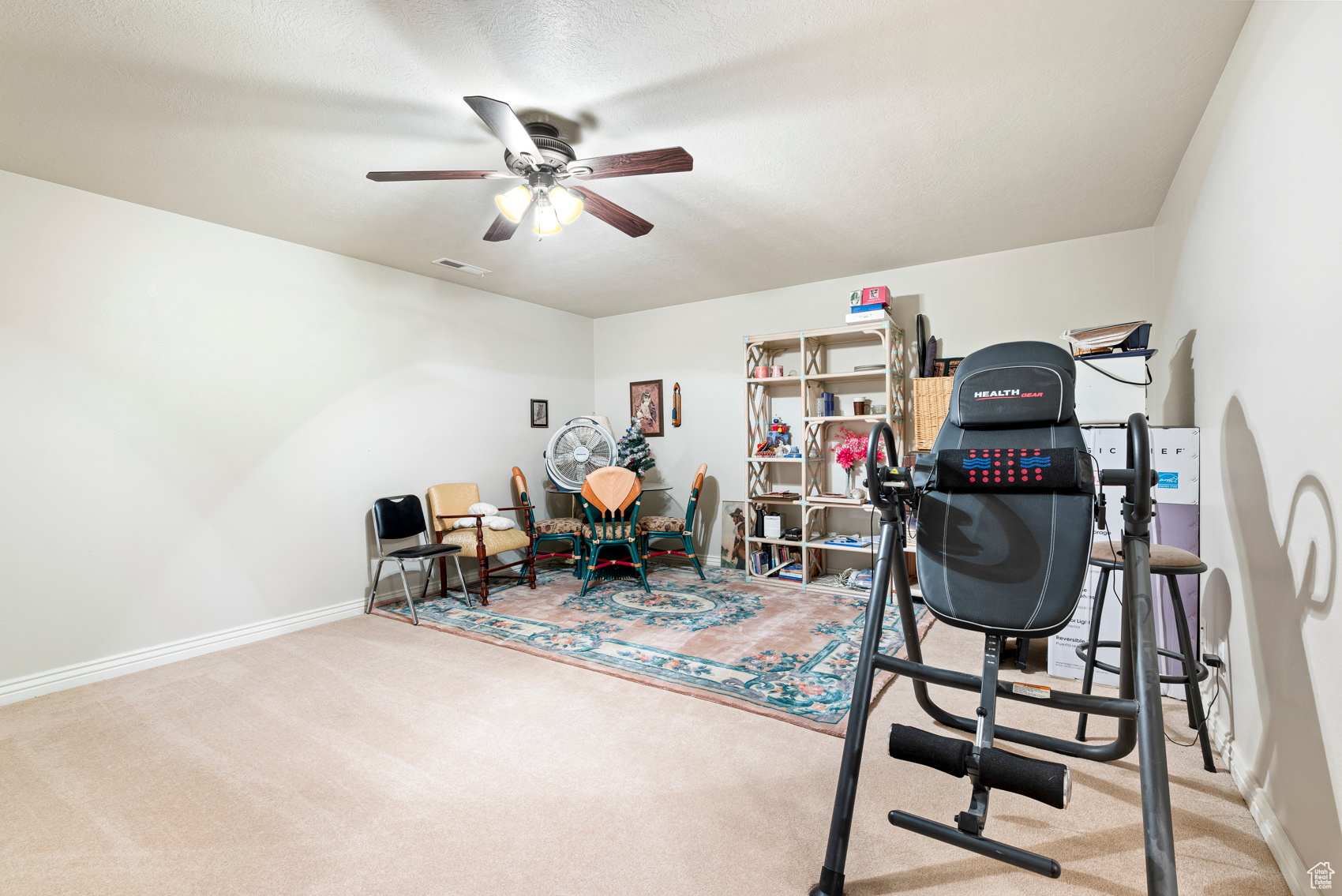 Workout room with carpet flooring and ceiling fan