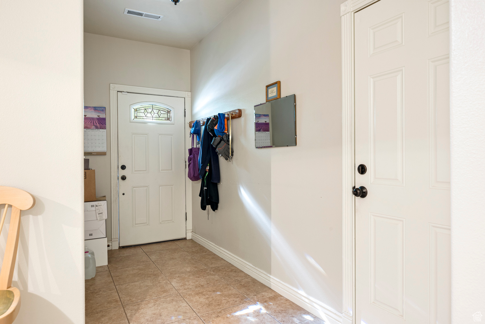 Entryway with light tile floors