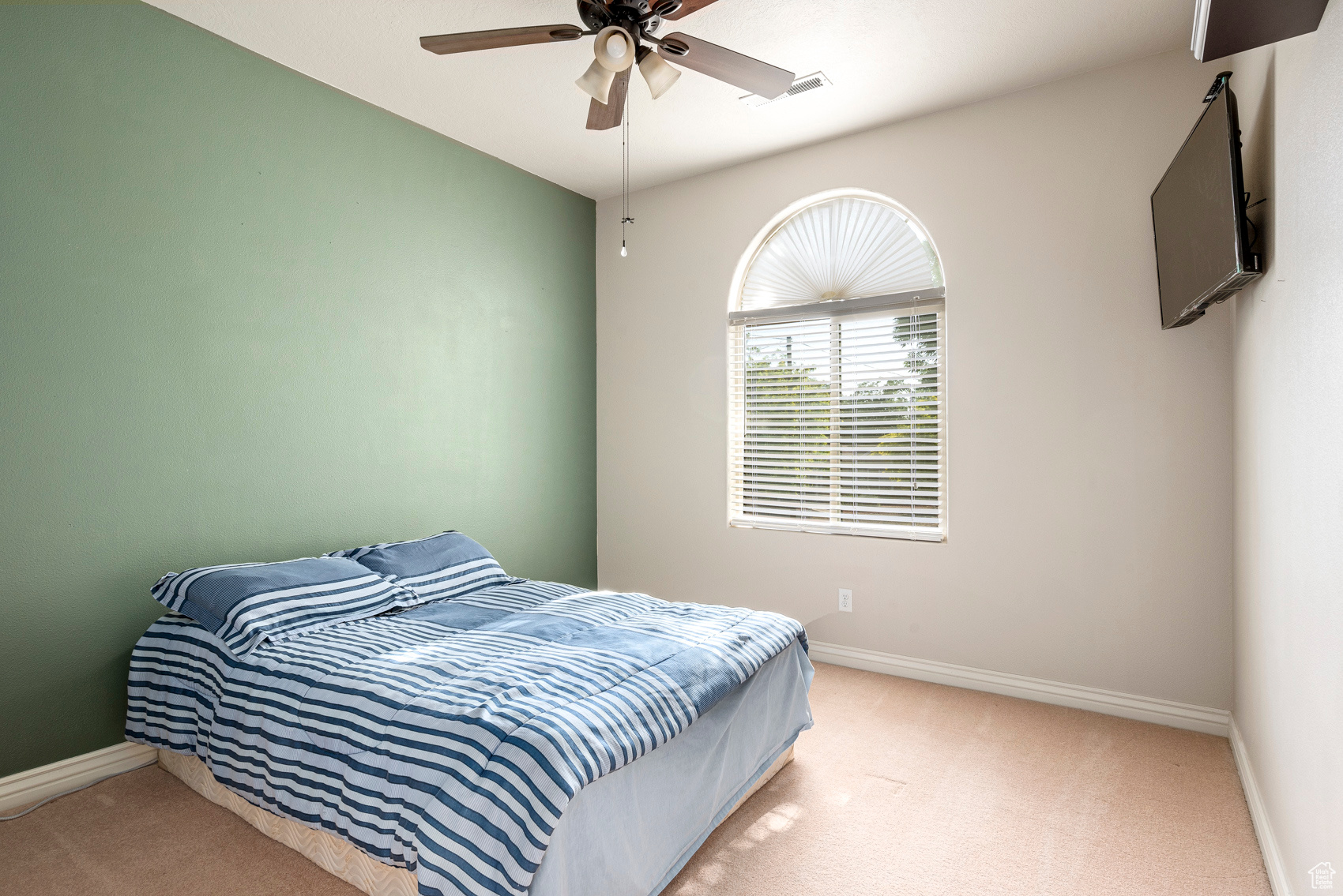 Bedroom with ceiling fan and carpet flooring