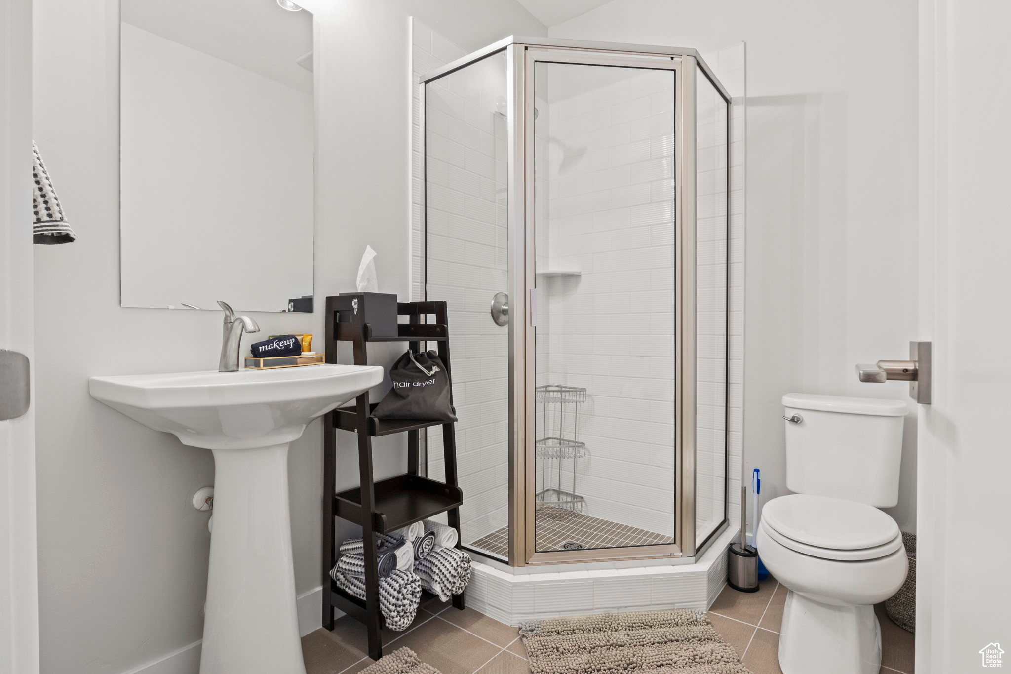 Bathroom with walk in shower, toilet, and tile floors