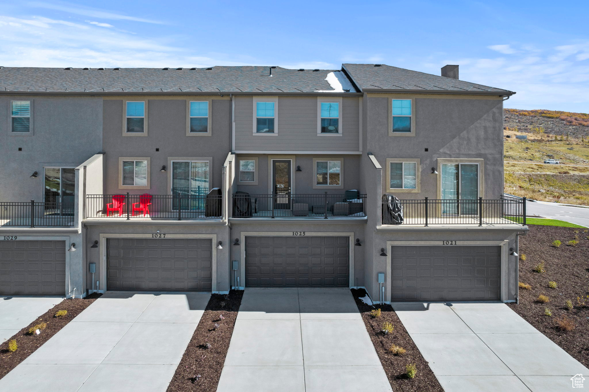 View of property with a balcony and a garage