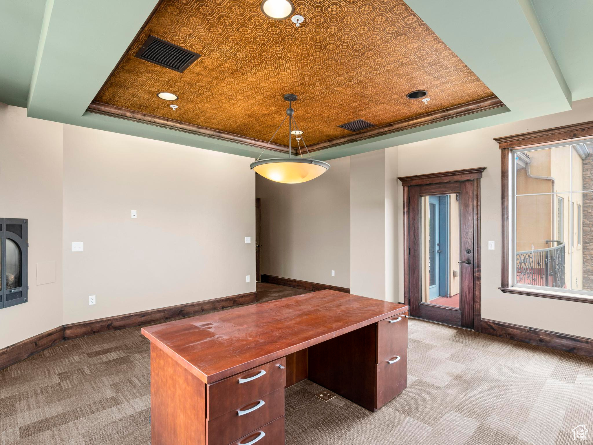 Unfurnished office with french doors, carpet floors, and a tray ceiling