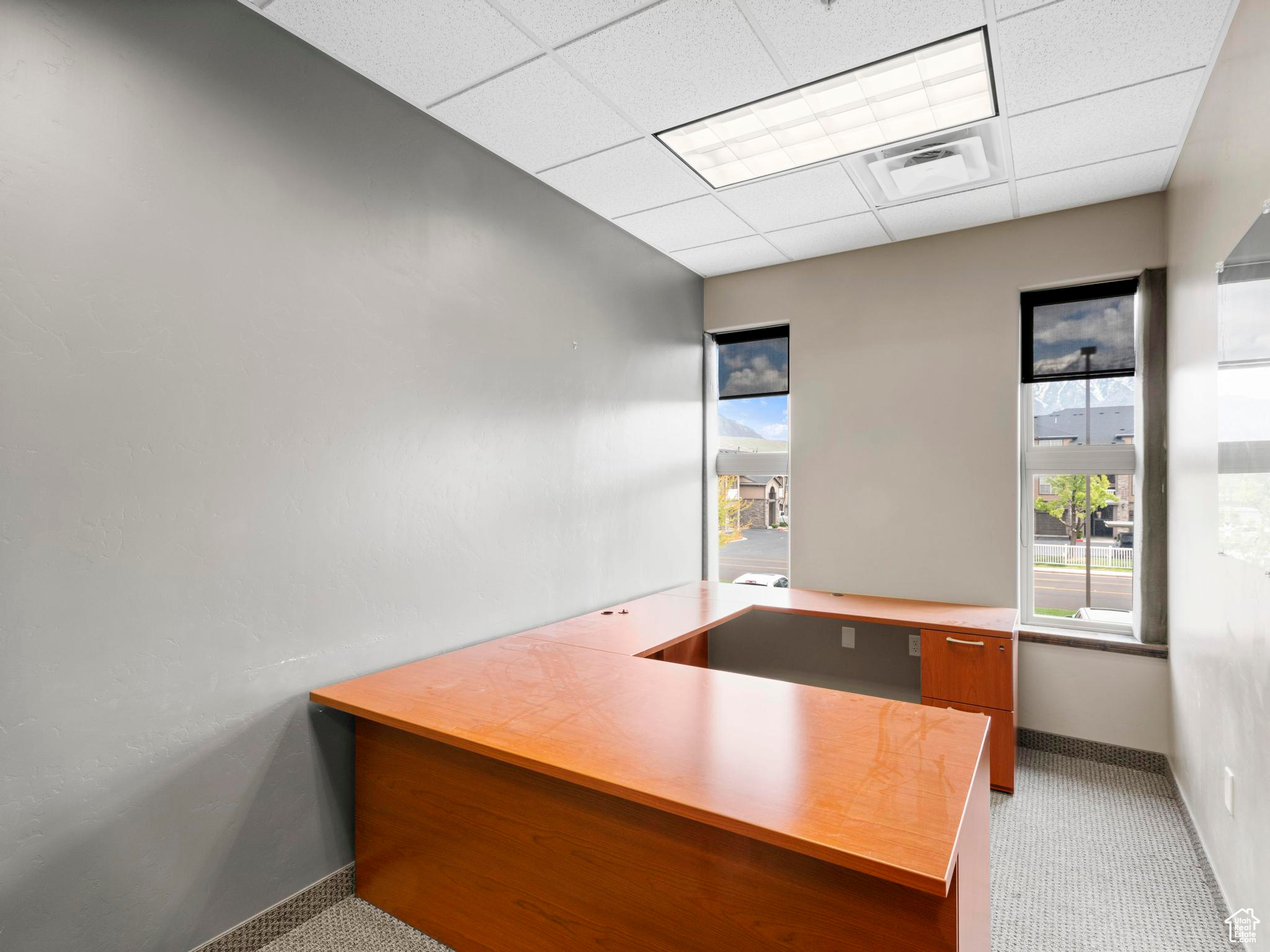 Unfurnished office featuring a drop ceiling